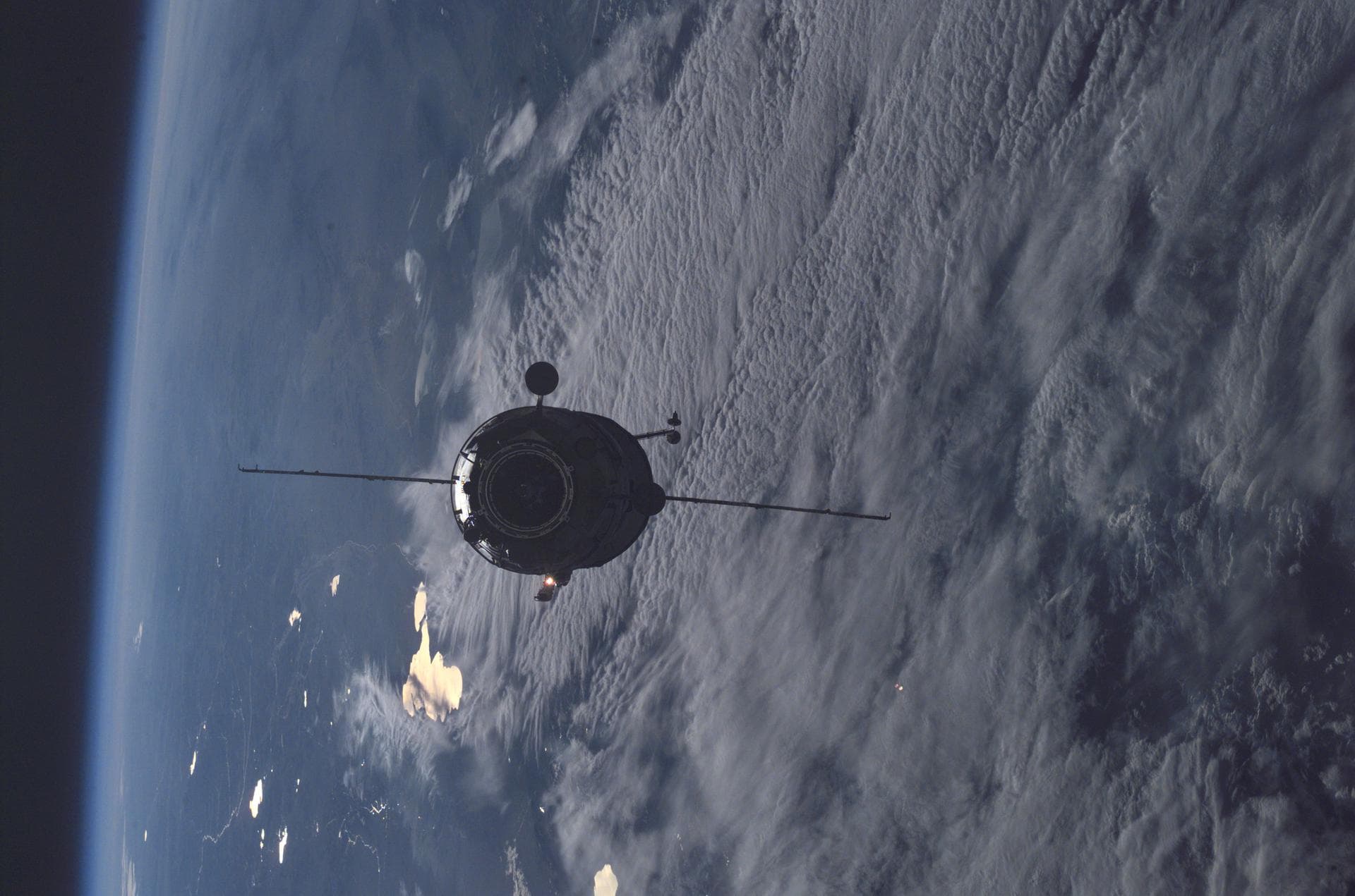 Enroute for docking, the 16-foot-long Russian docking compartment Pirs (the Russian word for pier) approaches the International Space Station (ISS). Pirs will provide a docking port for future Russian