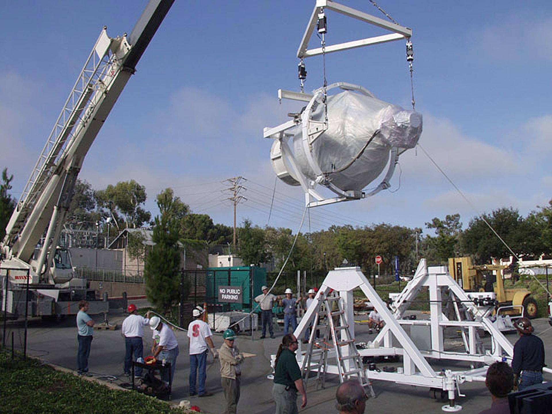 The Gravity Probe B (GP-B) payload was hoisted by crane to the transportation truck in the W.W. Hansen Experimental Physics Laboratory in Stanford, California for shipment to the launch site at Vanden