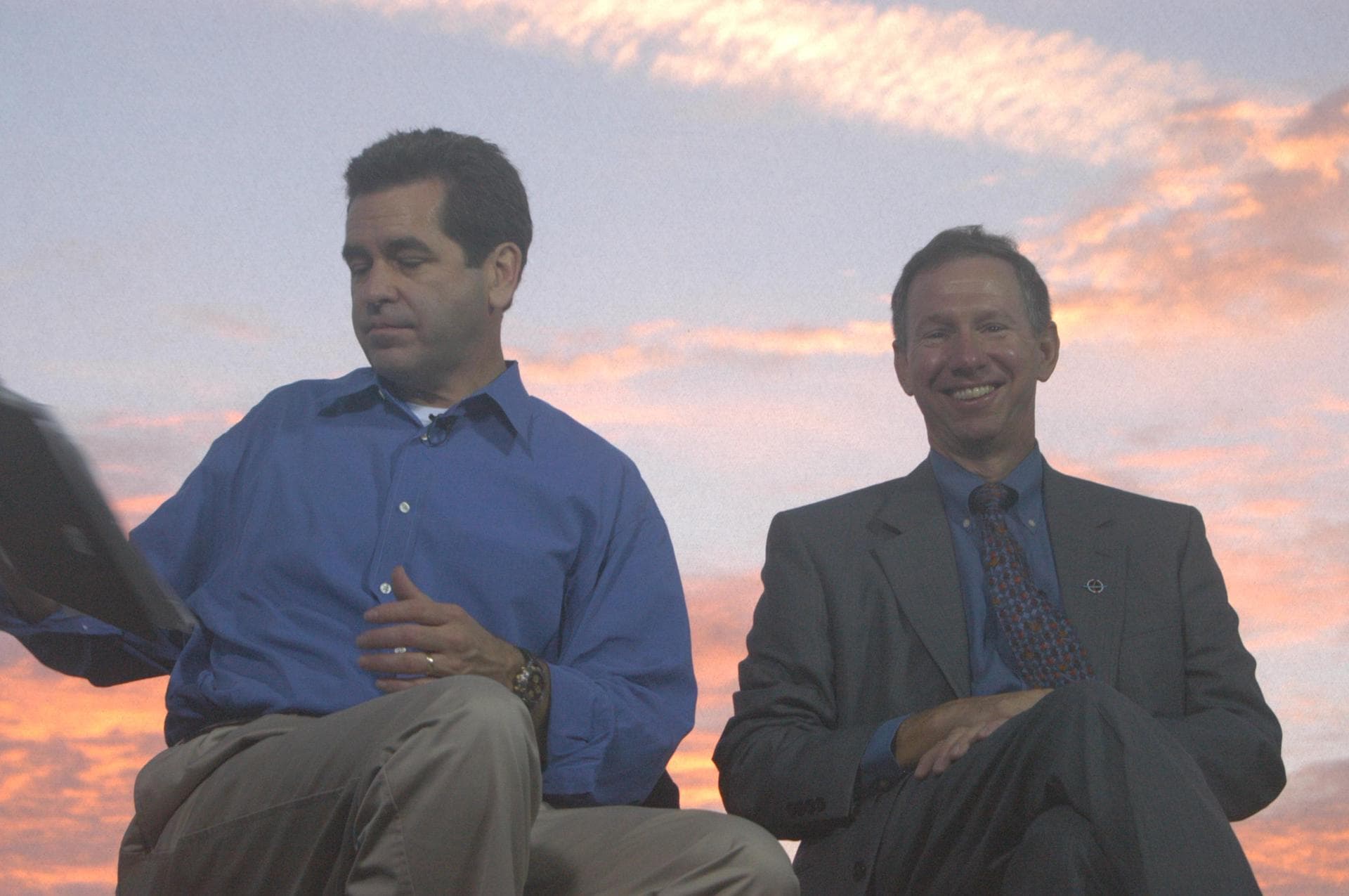 KENNEDY SPACE CENTER, FLA. - Against a sunrise-painted sky at NASA Kennedy Space Center, Miles O’Brien (left), co-anchor on CNN’s American Morning, checks his notes during a talk on air with NASA Ad