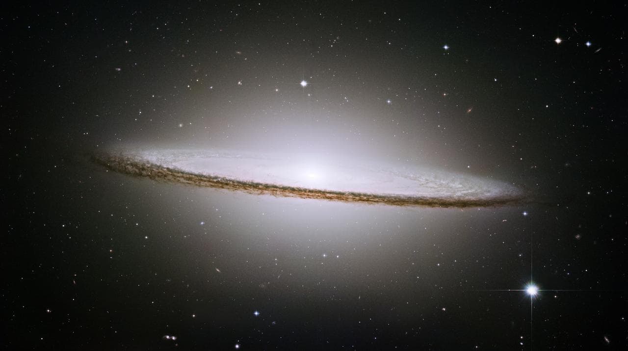 In the 19th century, astronomer V. M. Slipher first discovered a hat-like object that appeared to be rushing away from us at 700 miles per second. This enormous velocity offered some of the earliest c