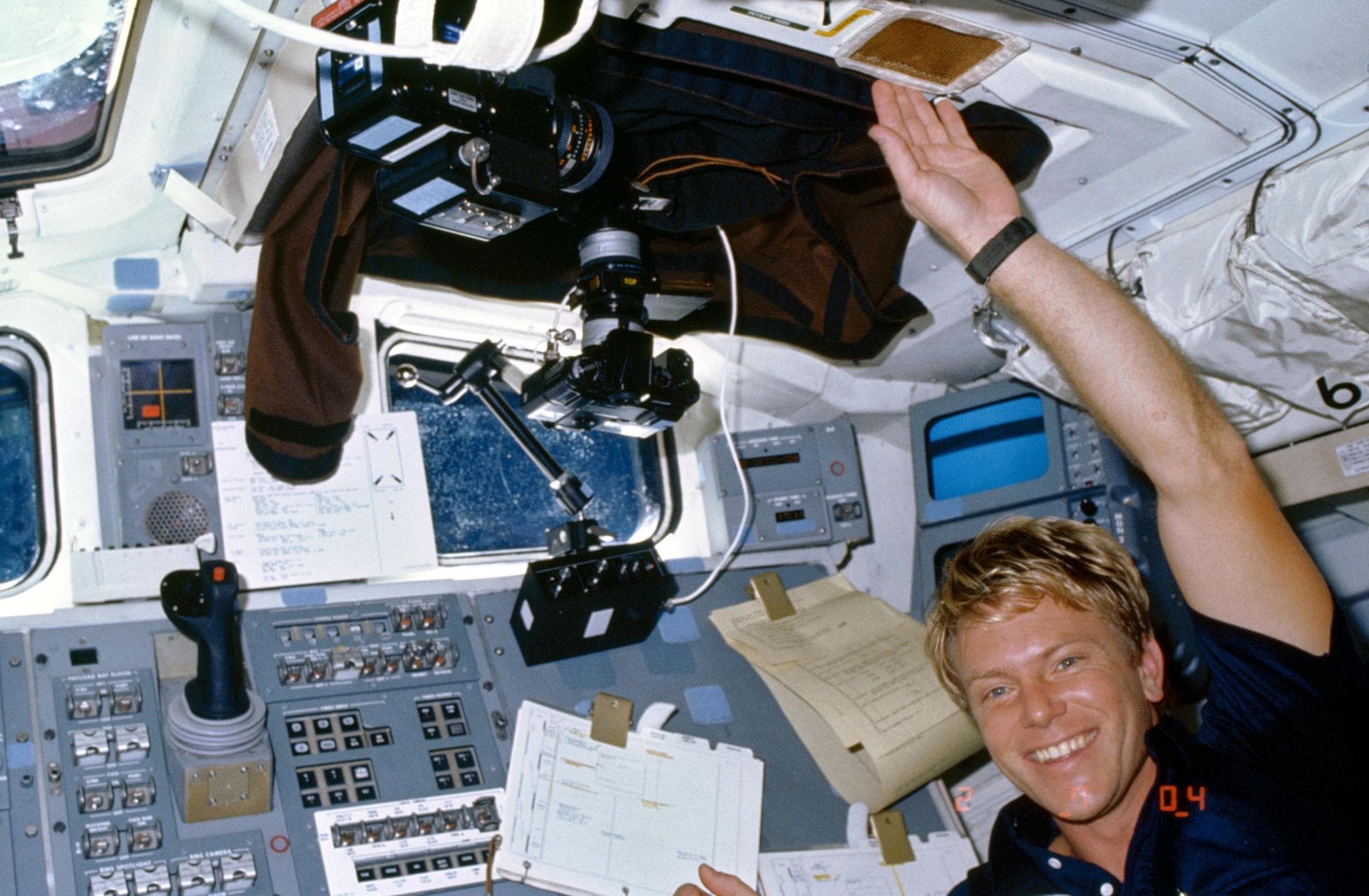 61C-05-026 (14 Jan. 1986) --- Astronaut George D. Nelson smiles for a fellow crew man's 35mm camera exposure while participating in the Comet Halley active monitoring program (CHAMP). Camera equipmen