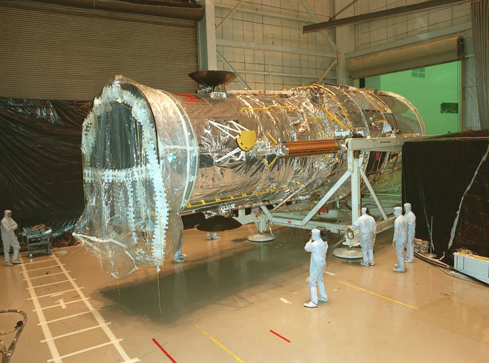 The Hubble Space Telescope (HST) being transferred from the Vertical Assembly Test Area (VATA) to the High Bay at the Lockheed assembly plant in preparation for transport to the Kennedy Space Center (