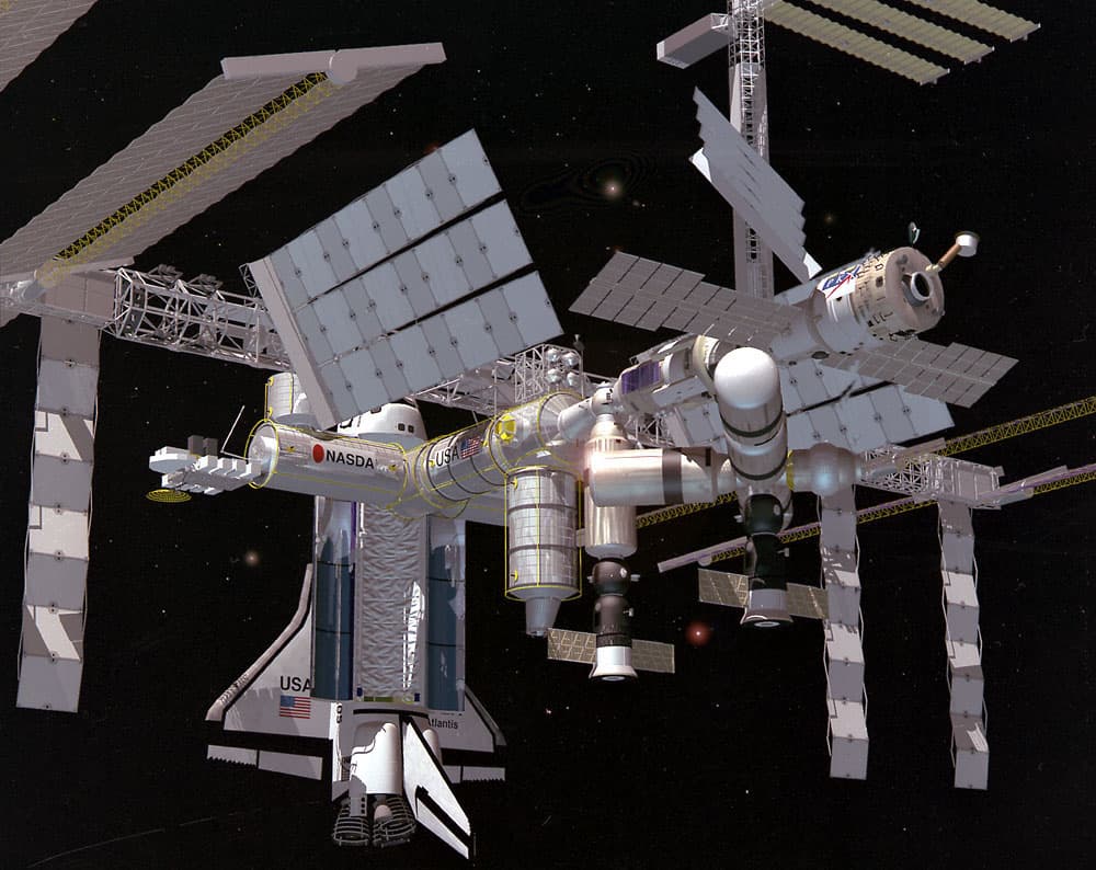 Artist's concept of the International Space Station (ISS) Alpha deployed and operational. This figure also includes the docking procedures for the Space Shuttle (shown with cargo bay open). The ISS is