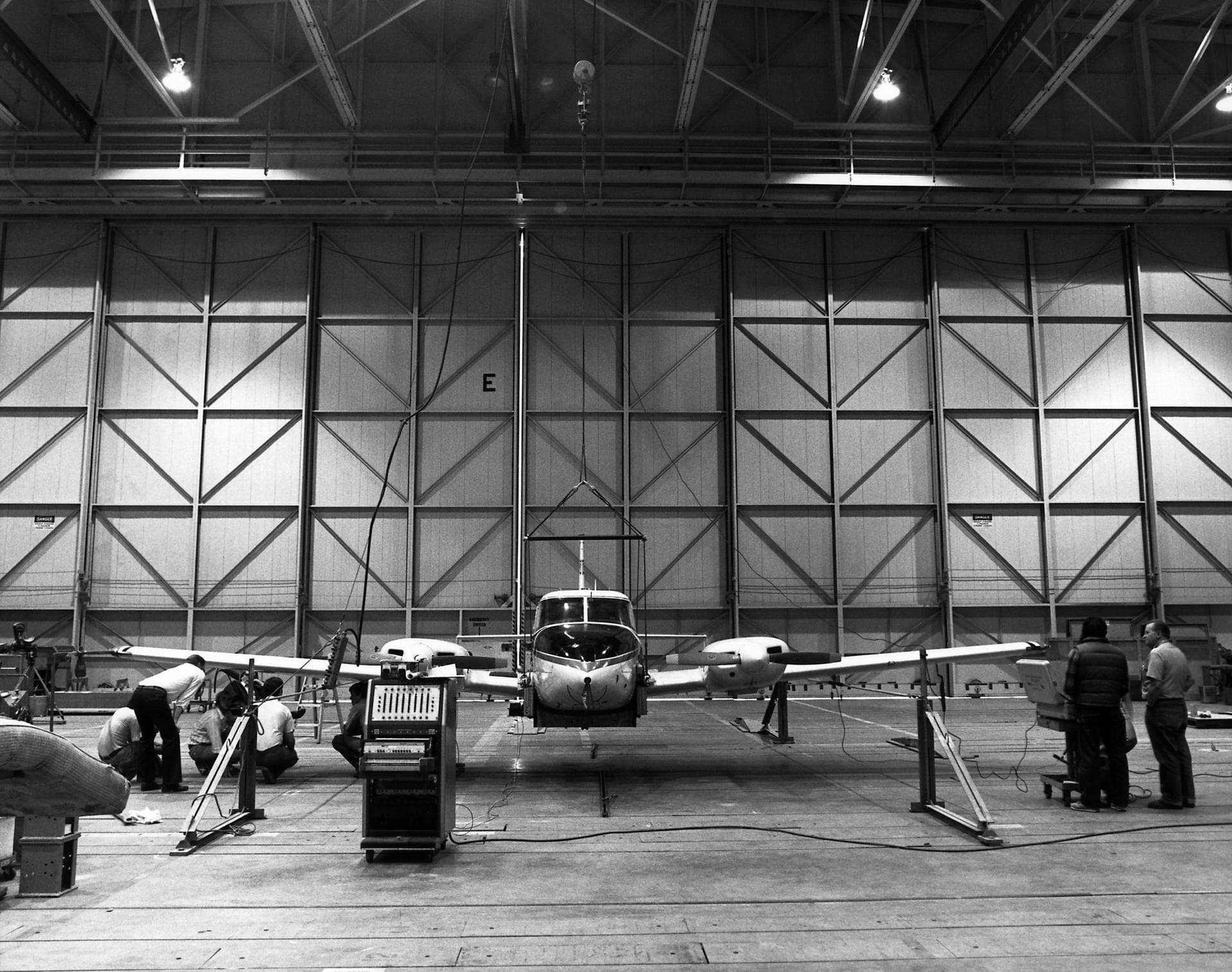 Technicians check instrumentation and systems on NASA 808, a PA-30 aircraft, prior to a research flight. The aircraft was used as the testbed in development of control systems for remotely piloted veh
