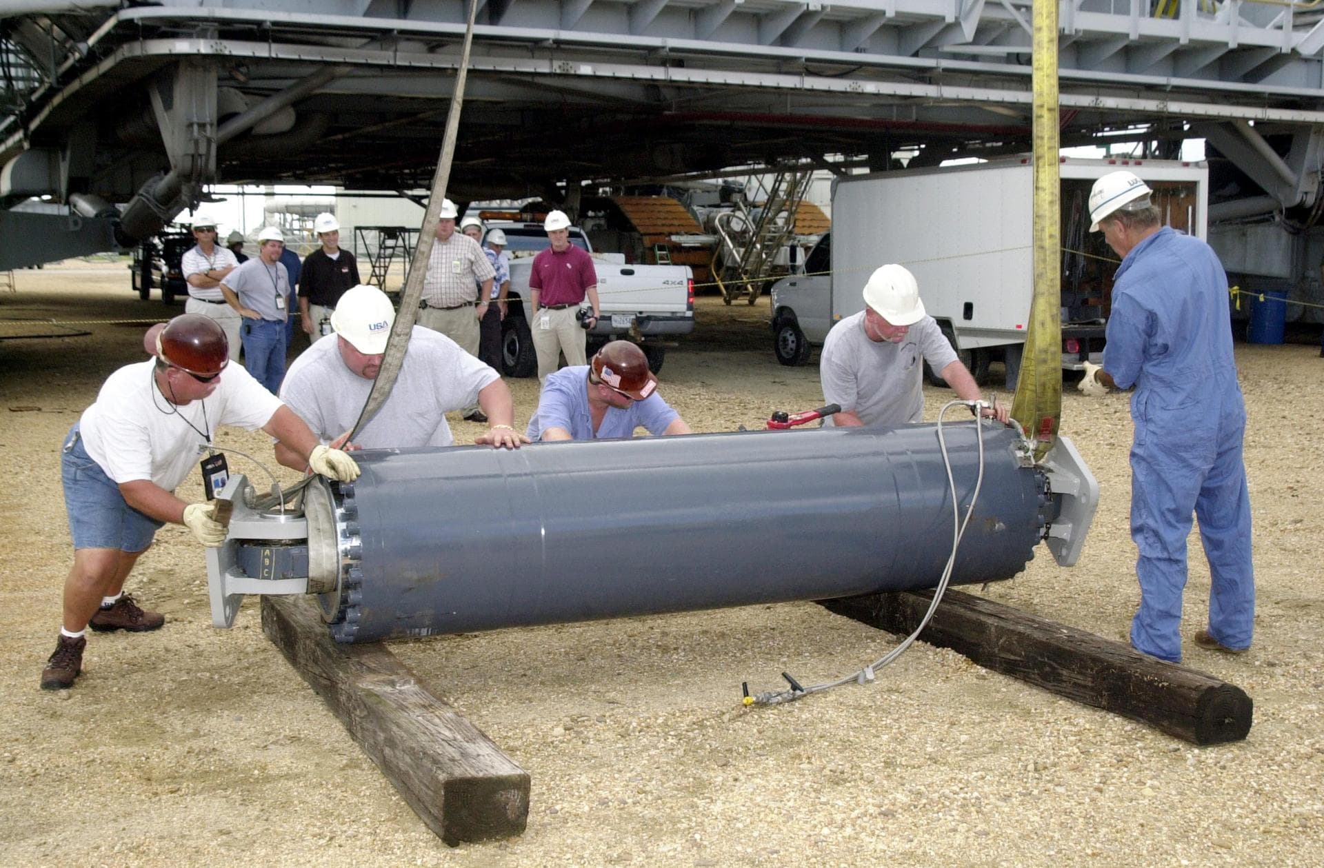 KENNEDY SPACE CENTER, FLA. -- At the crawler parking area, one of the repaired Jacking, Equalization and Leveling (JEL) cylinders is positioned for hookup to a crane. The crane will lift the JEL for