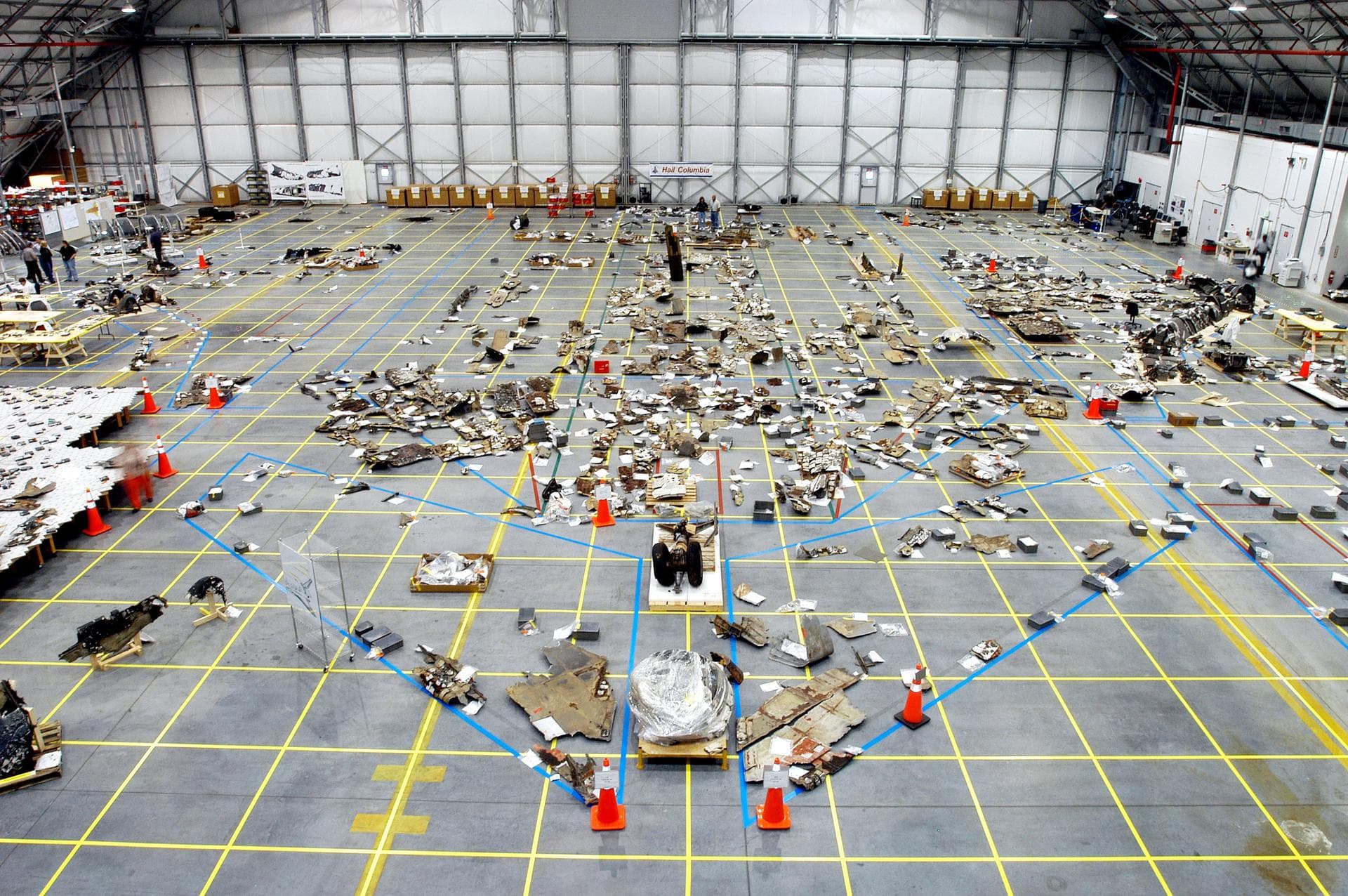 KENNEDY SPACE CENTER, FLA. - An overview of the Columbia debris hangar shows the orbiter outline on the floor with some of the 78,760 pieces identified to date.  More than 82,500 pieces of shuttle deb