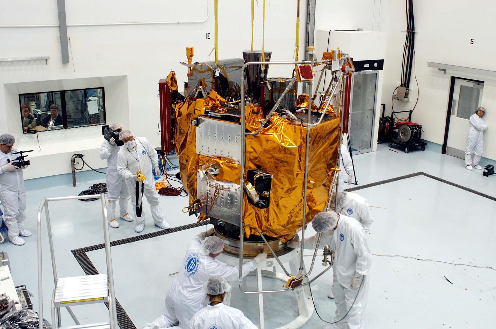 KENNEDY SPACE CENTER, FLA. -  At the Astrotech Space Operations processing facilities, workers check the placement of NASA’s MESSENGER spacecraft on a work stand. There employees of the Johns Hopkins 