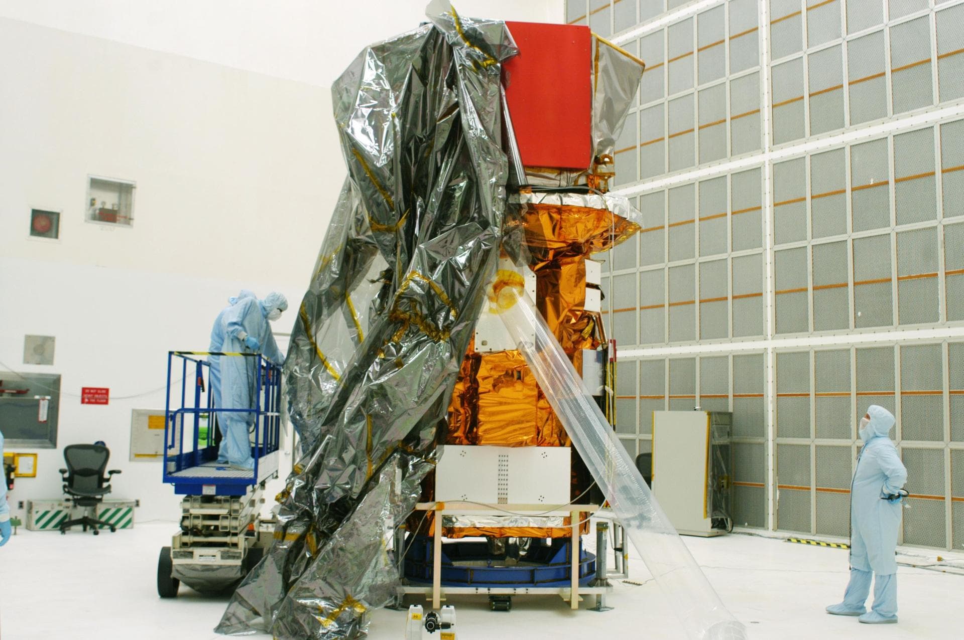 KENNEDY SPACE CENTER, FLA. - The Swift spacecraft is being unwrapped in Hangar AE at Cape Canaveral Air Force Station.  Swift is a first-of-its-kind, multi-wavelength observatory dedicated to the stud