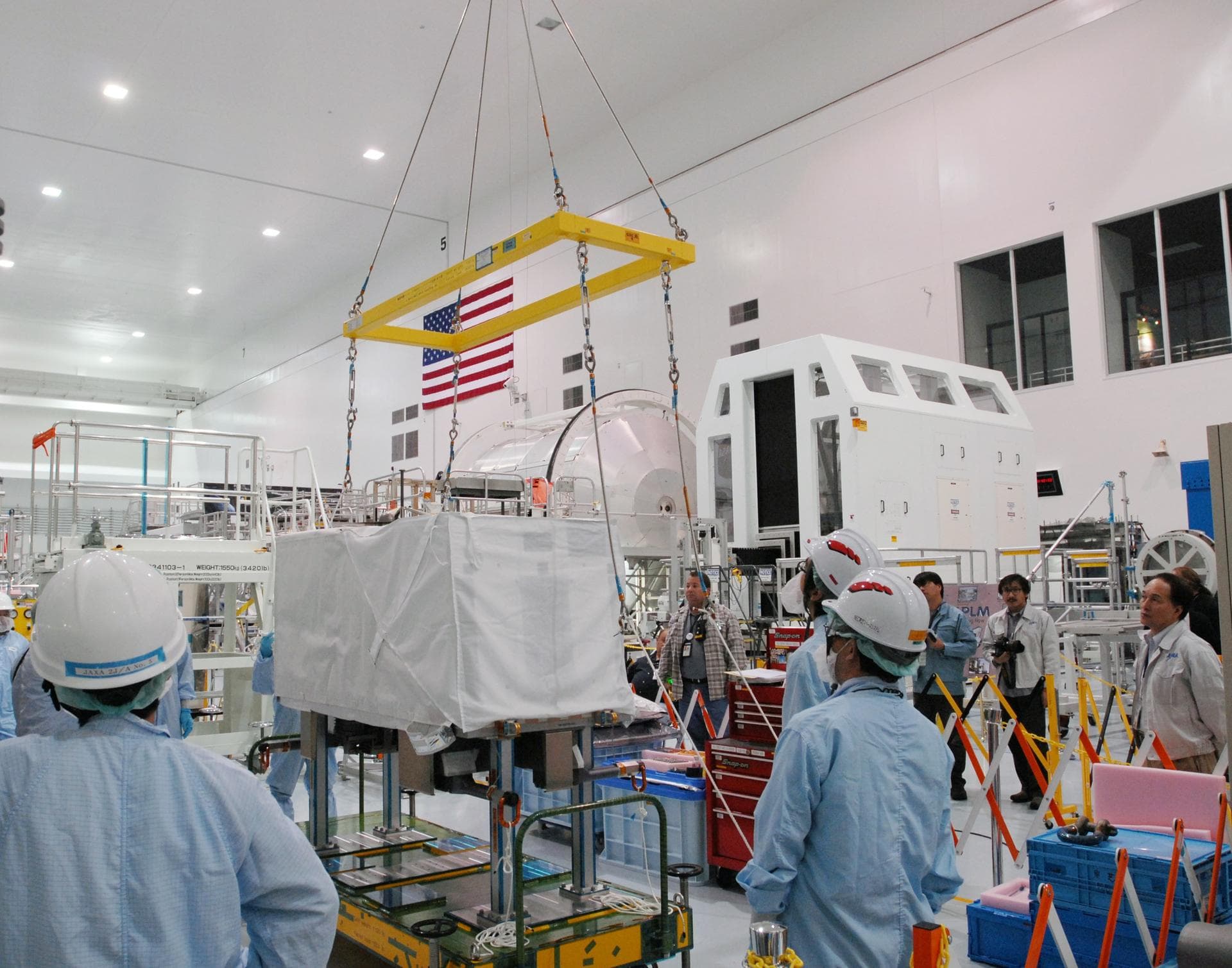 CAPE CANAVERAL, Fla. --  In the Space Station Processing Facility at NASA's Kennedy Space Center in Florida, a crane is moved over the MAXI (Monitor of All-sky X-ray Image). The crane will lift the MA