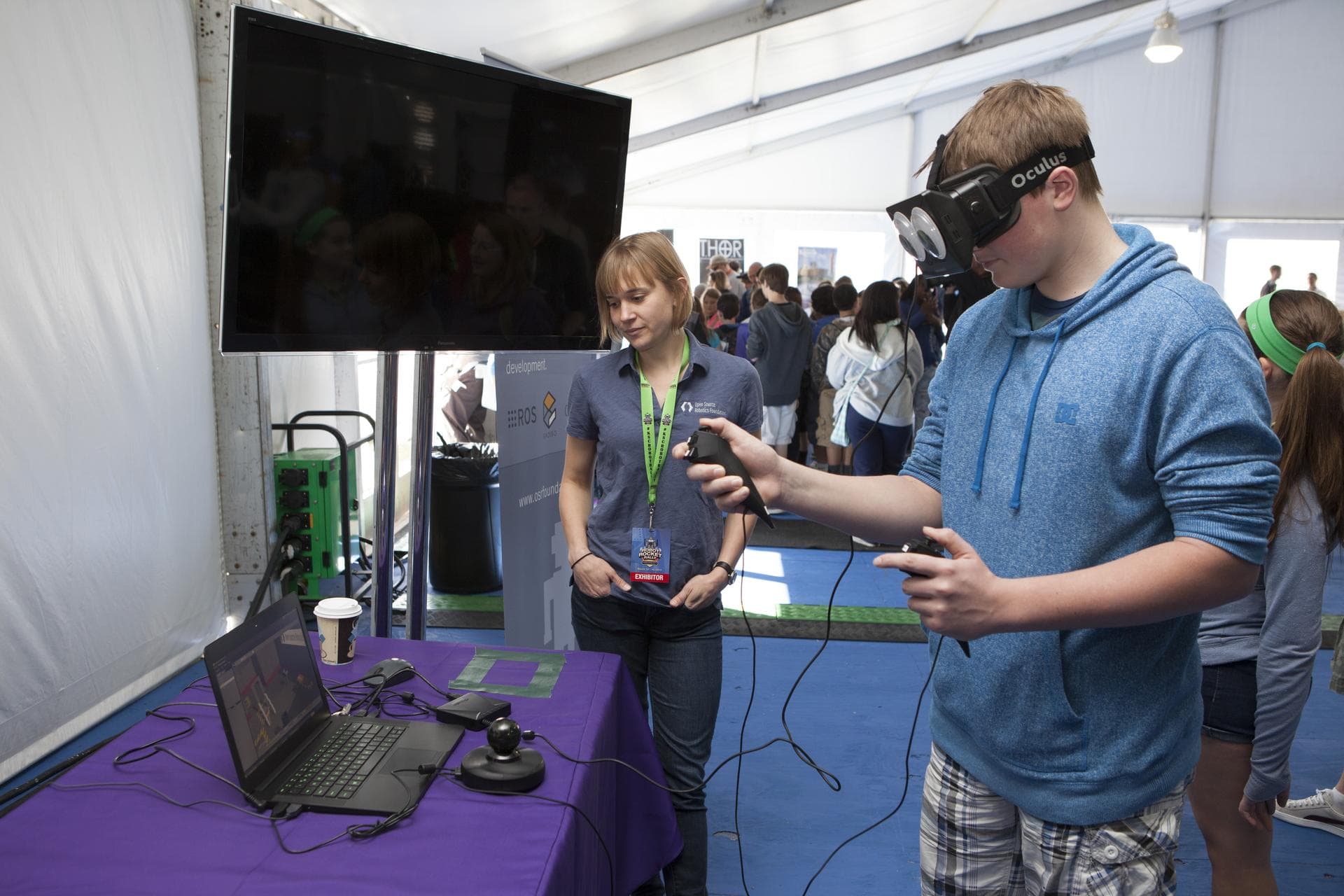 CAPE CANAVERAL, Fla. – A visitor to the Robot Rocket Rally tries his hand at virtual reality in a demonstration of the Oculus Rift technology, provided by the Open Source Robotics Foundation. The thre