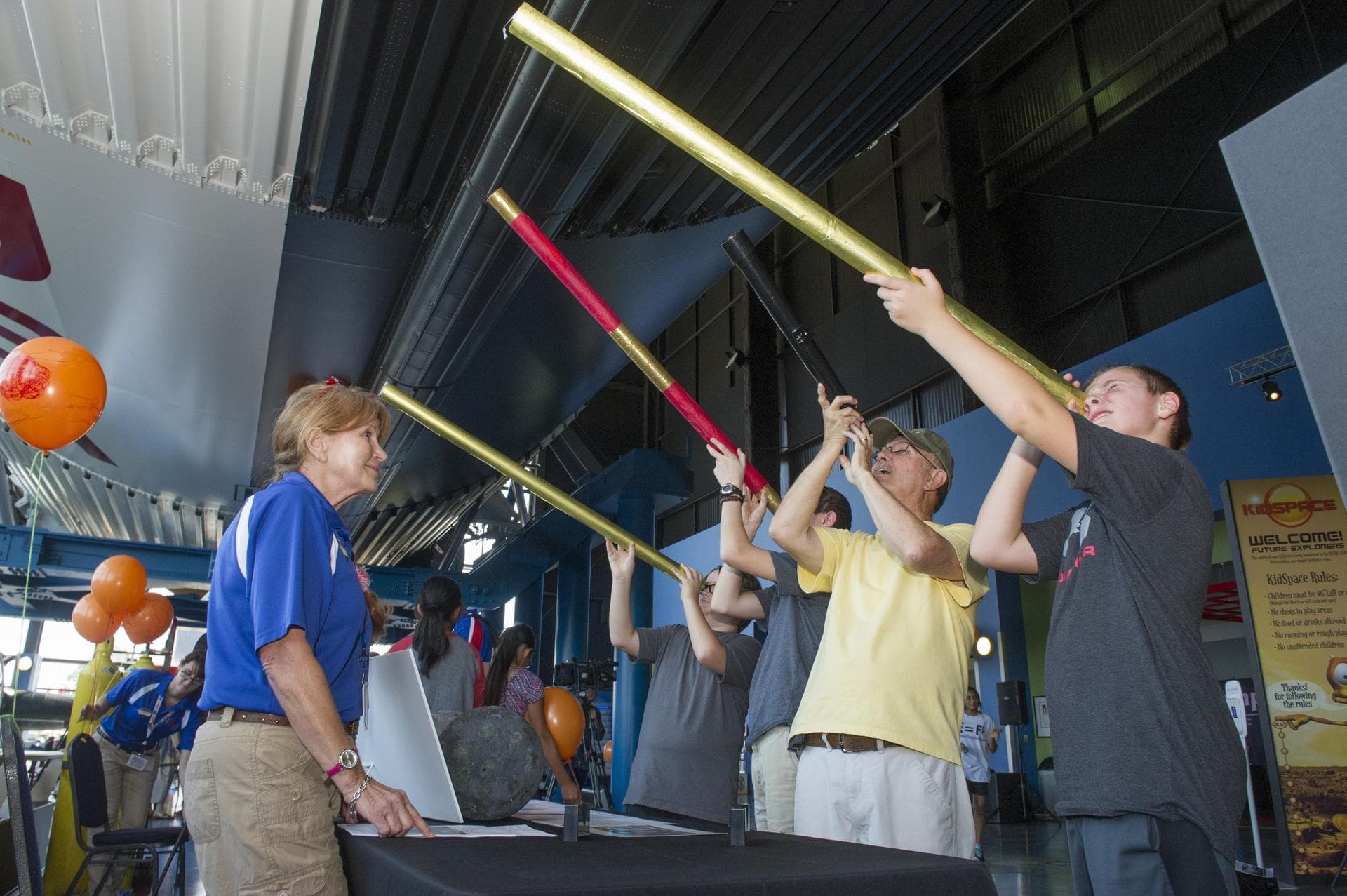 JOHN TUCKER AND HIS THREE GRANDSONS VIEW JUPITER SIMULATION THROUGH TELESCOPES