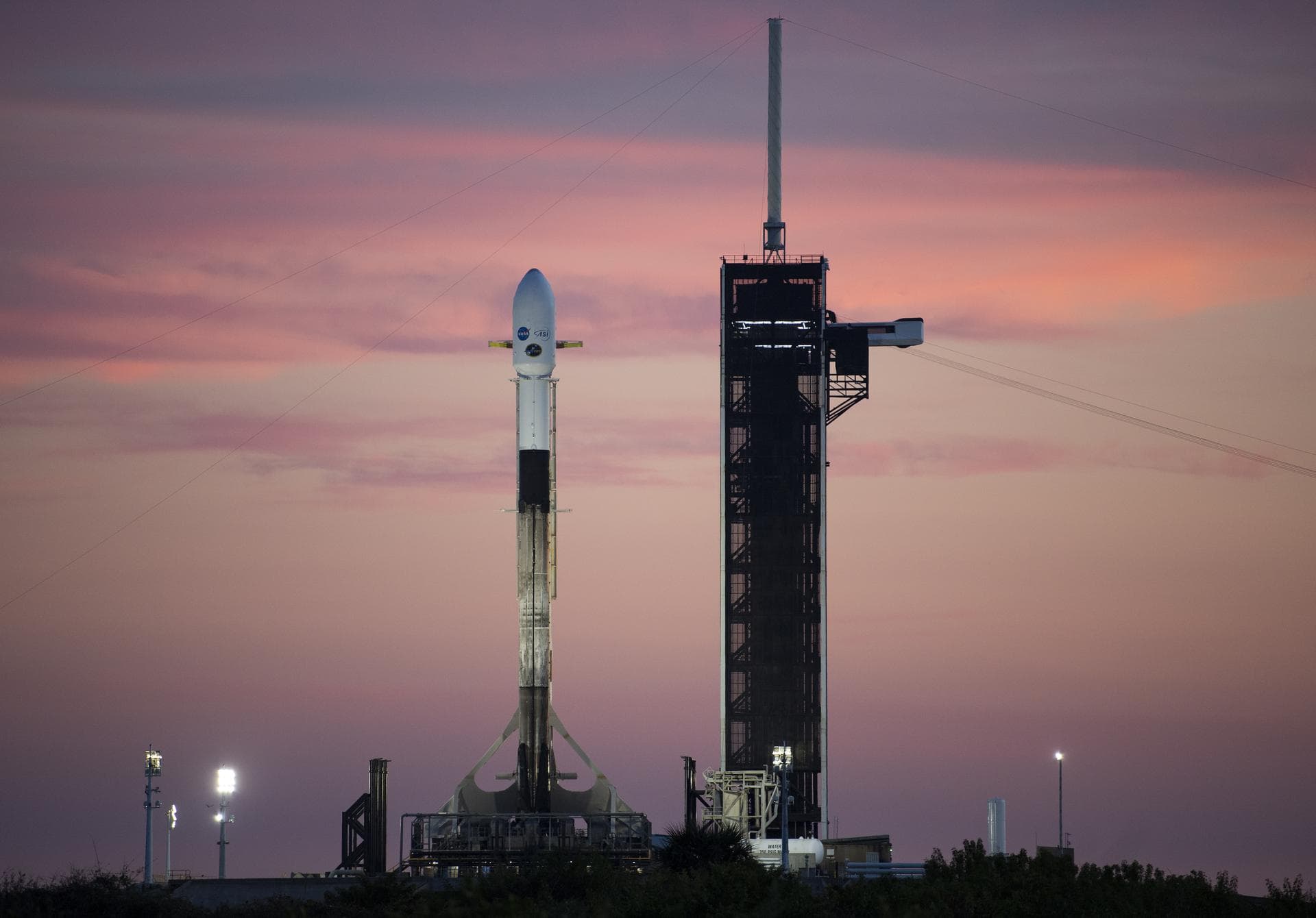 A SpaceX Falcon 9 rocket carrying NASA’s Imaging X-ray Polarimetry Explorer (IXPE) spacecraft is seen at sunset on the launch pad at Launch Complex 39A, Wednesday, Dec. 8, 2021, at NASA’s Kennedy Spac