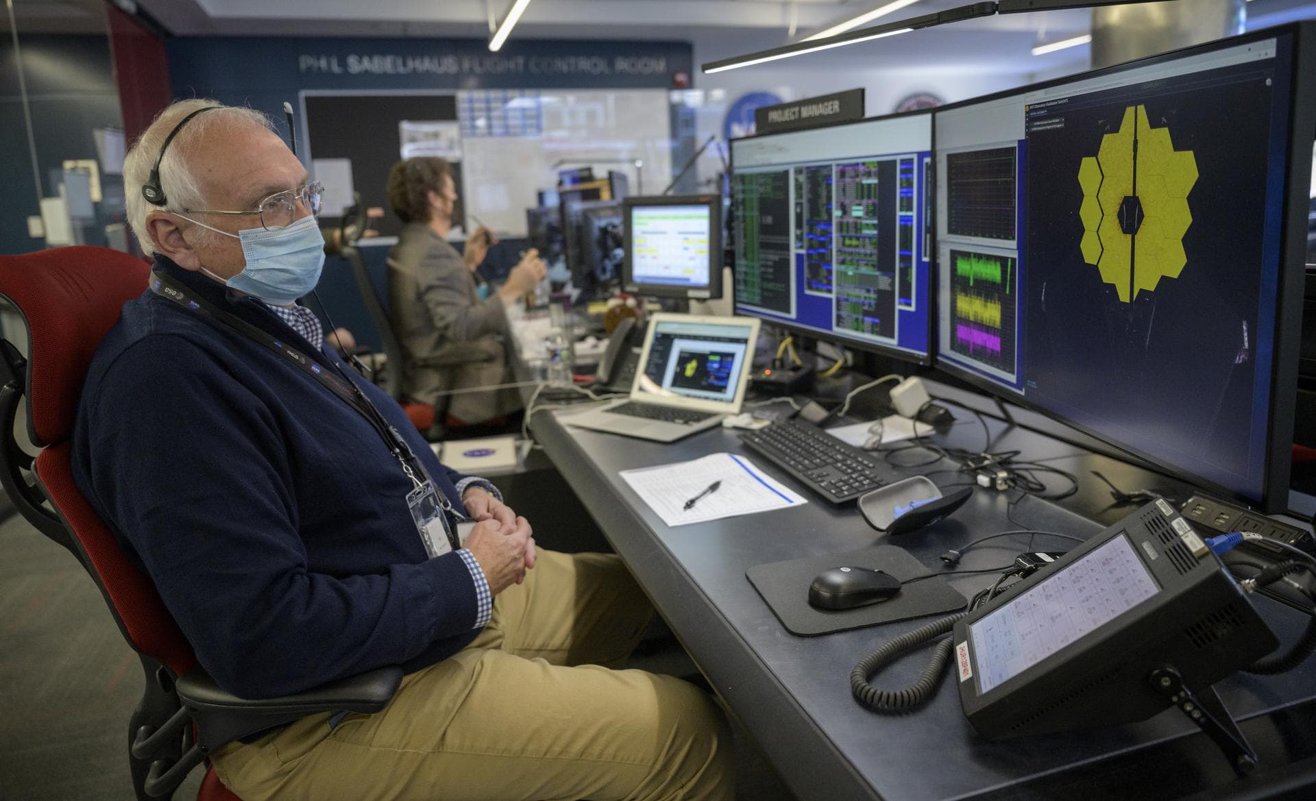 NASA James Webb Space Telescope Project Manager Bill Ochs monitors the progress of the observatory’s second primary mirror wing as it rotates into position, Saturday, Jan. 8, 2022, from NASA’s James W