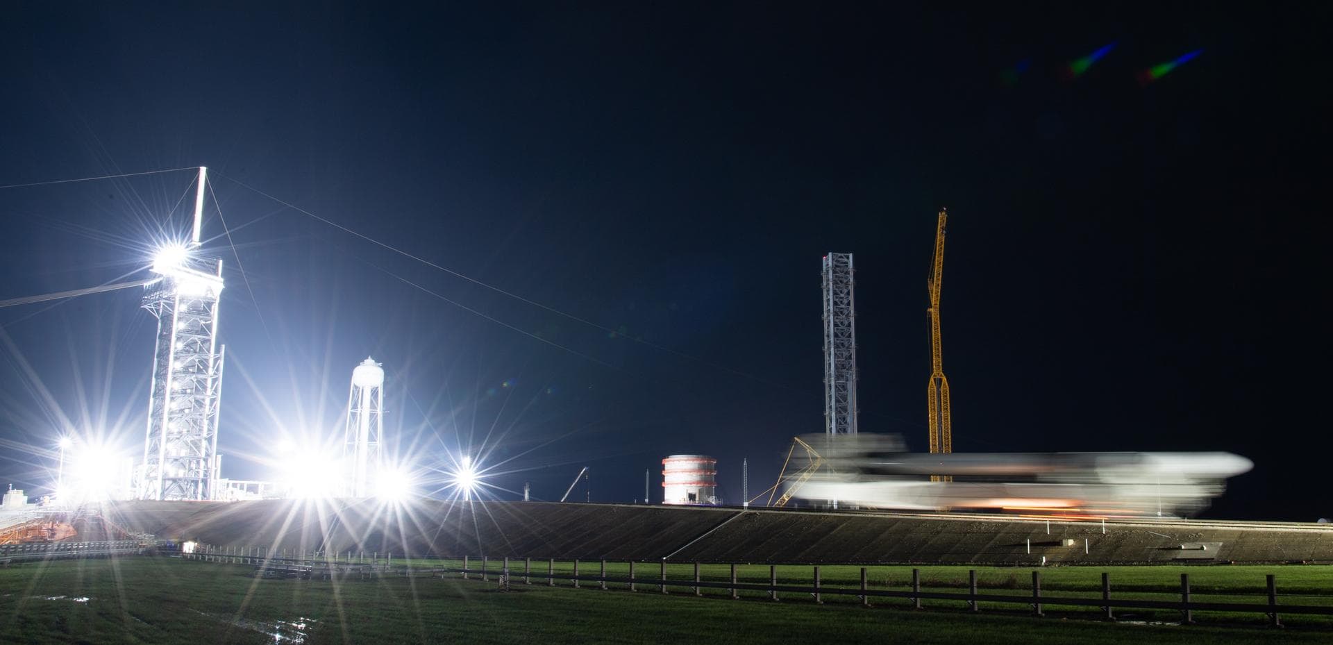 In this three-minute exposure, a SpaceX Falcon 9 rocket with the company's Crew Dragon spacecraft onboard is seen as it is rolled out to the launch pad at Launch Complex 39A as preparations continue f