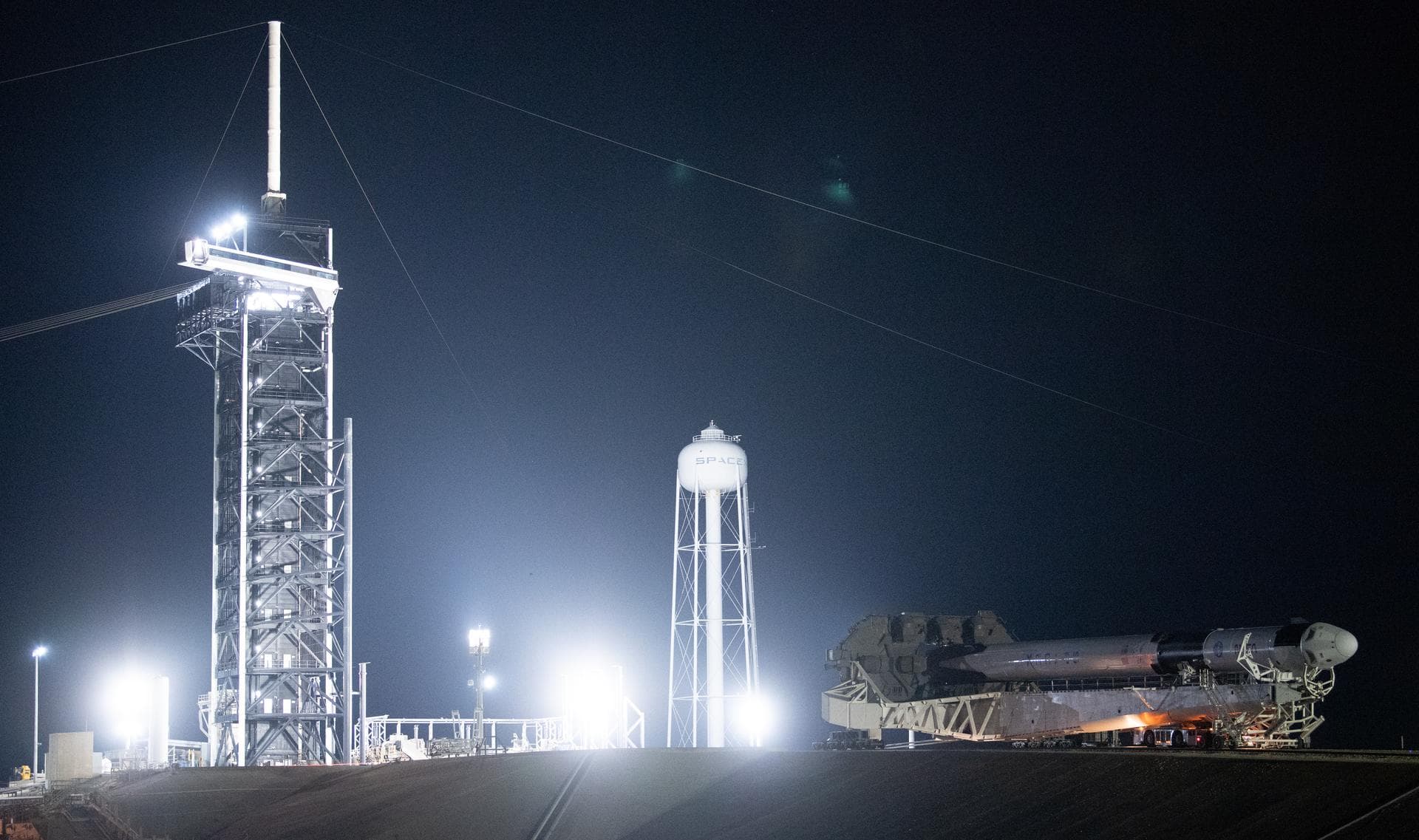 A SpaceX Falcon 9 rocket with the company's Crew Dragon spacecraft onboard is seen as it is rolled out to the launch pad at Launch Complex 39A as preparations continue for the Crew-5 mission, Saturday