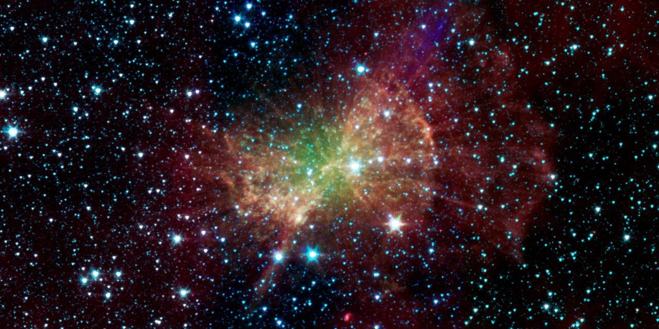 The Dumbbell nebula, also known as Messier 27, pumps out infrared light in this image from NASA Spitzer Space Telescope. Planetary nebulae are now known to be the remains of stars that once looked a l