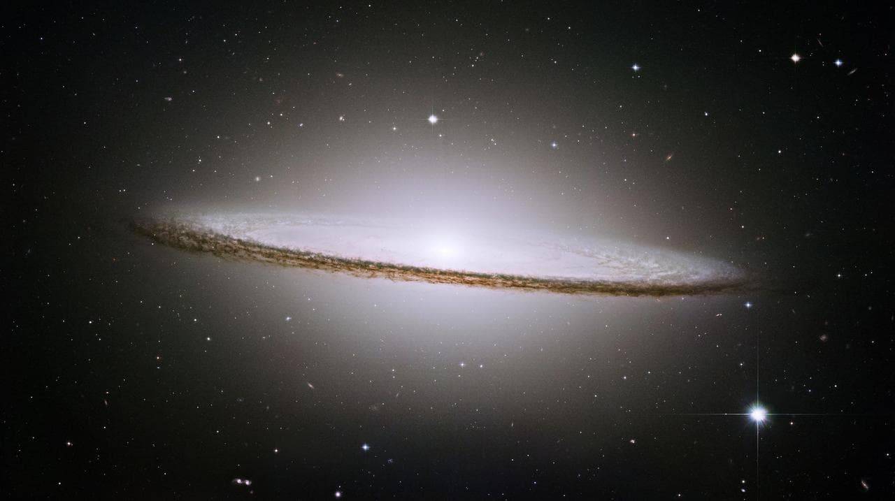 Lying at the southern edge of the rich Virgo cluster of galaxies, Messier 104, also called the Sombrero galaxy, is one of the most famous objects in the sky in this image from NASA Hubble Space Telesc