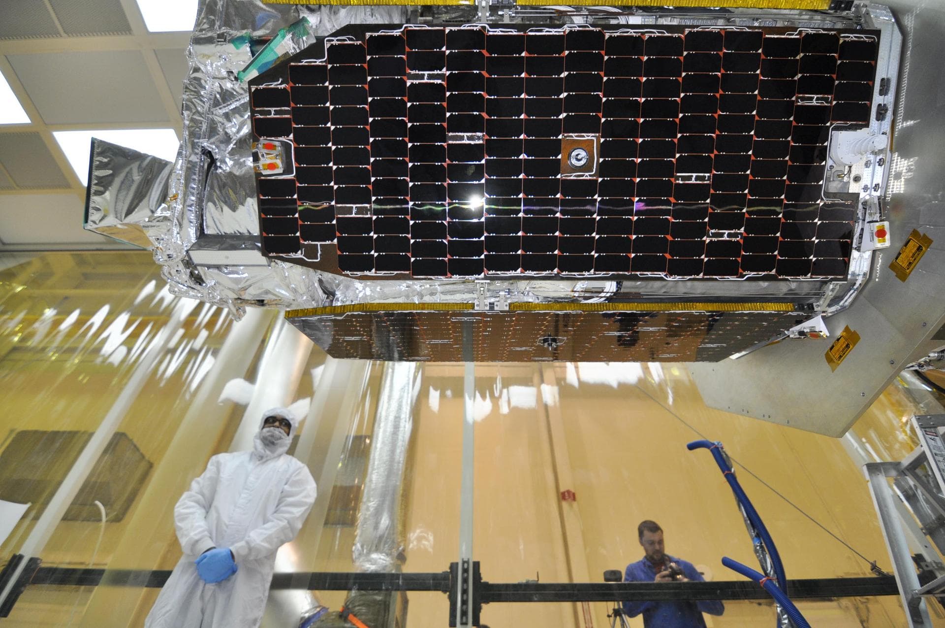 Inside an environmental enclosure at Vandenberg Air Force Base processing facility in California, solar panels line the sides of NASA Nuclear Spectroscopic Telescope Array NuSTAR, which was just joine