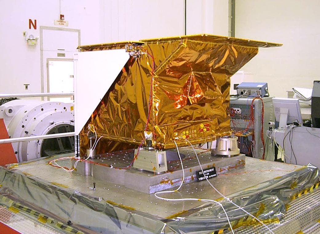 Technicians install NASA's Tropospheric Emission Spectrometer (TES) instrument on NASA's Aura spacecraft prior to launch. Launched in July 2004 and designed to fly for two years, the TES mission is cu
