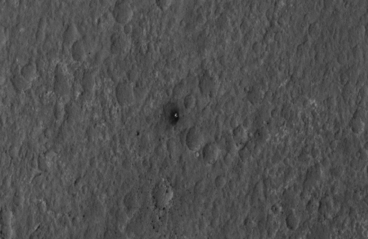 This close-up view shows Curiosity heat shield, which helped the rover survive the harrowing journey through the Martian atmosphere, on the surface of Mars. NASA Mars Reconnaissance Orbiter about 24 h