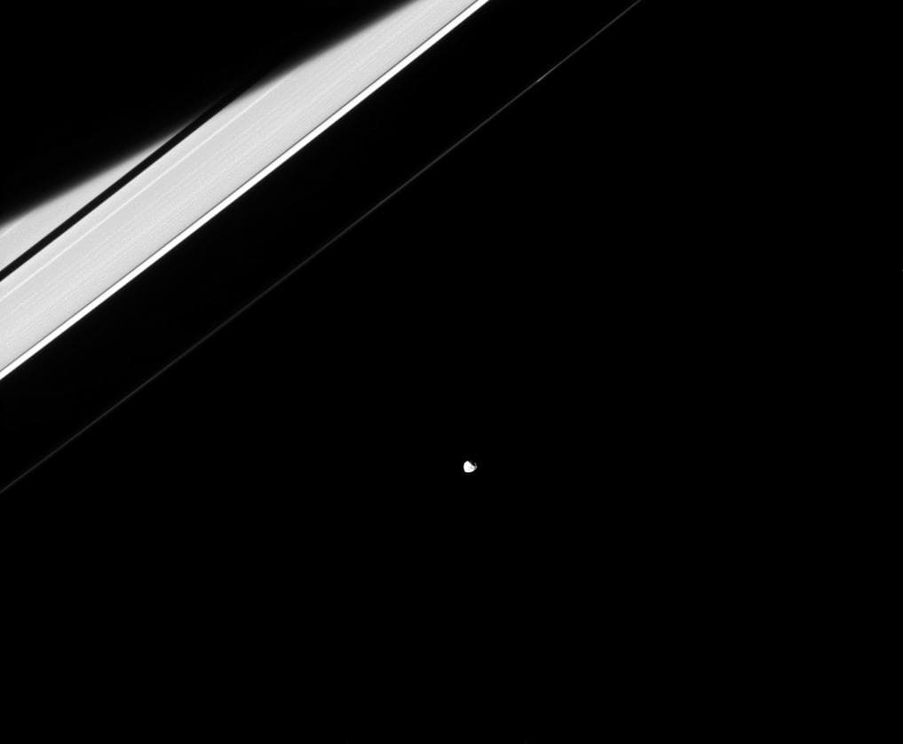 In reality, Janus and the rings both orbit Saturn and are only weakly connected to each other through their mutual gravitational tugs. At specific locations in the rings, these gravitational tugs resu