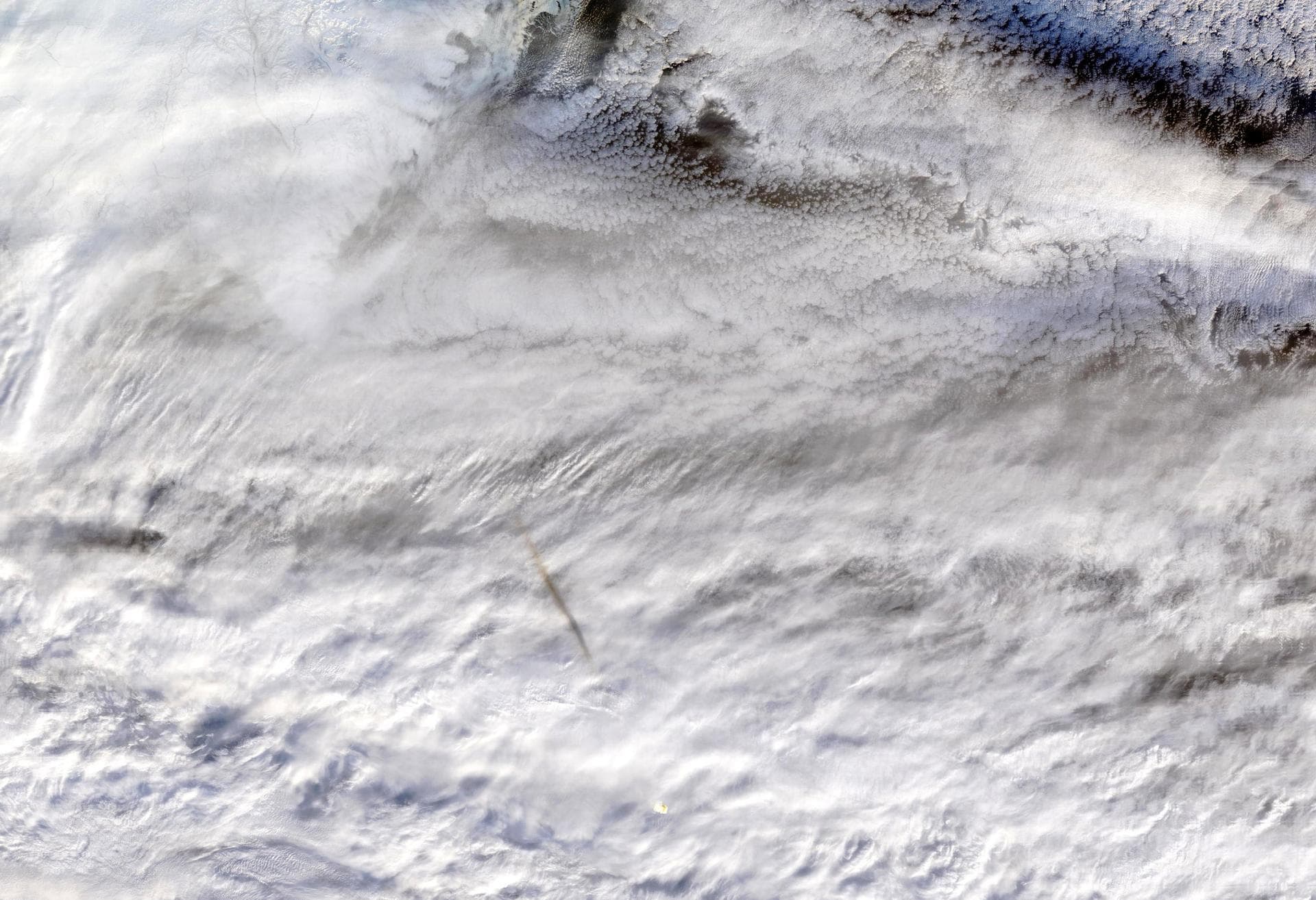 NASA's Moderate Resolution Imaging SpectroRadiometer (MODIS) instrument, aboard the Terra satellite, captured this true-color image showing the remnants of a meteor's passage, seen as a dark shadow ca