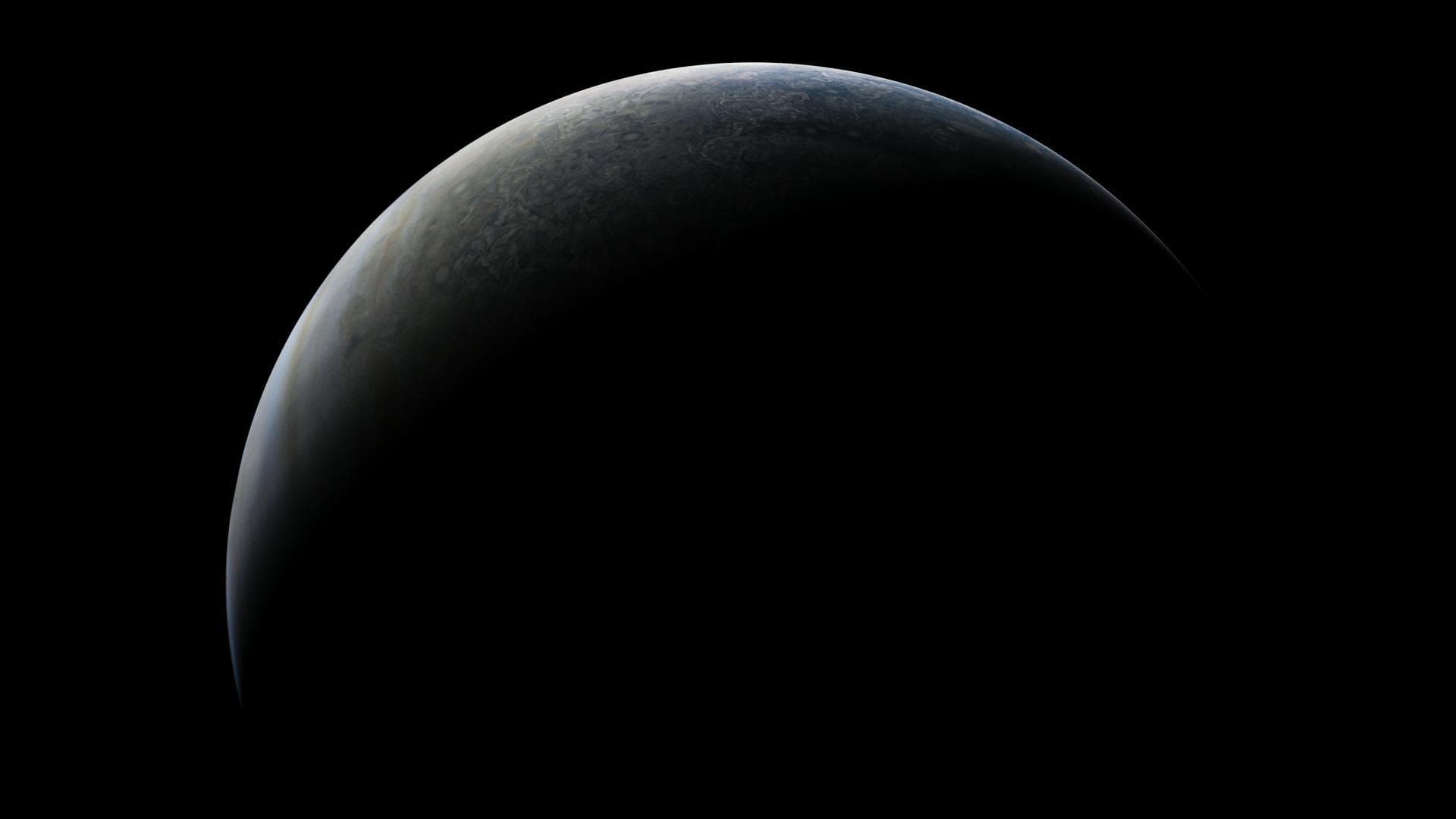 If you could ride along with NASA's Juno spacecraft as it approaches Jupiter during one of its regular close passes by the giant planet, you would be treated to a striking vista similar to this one.  