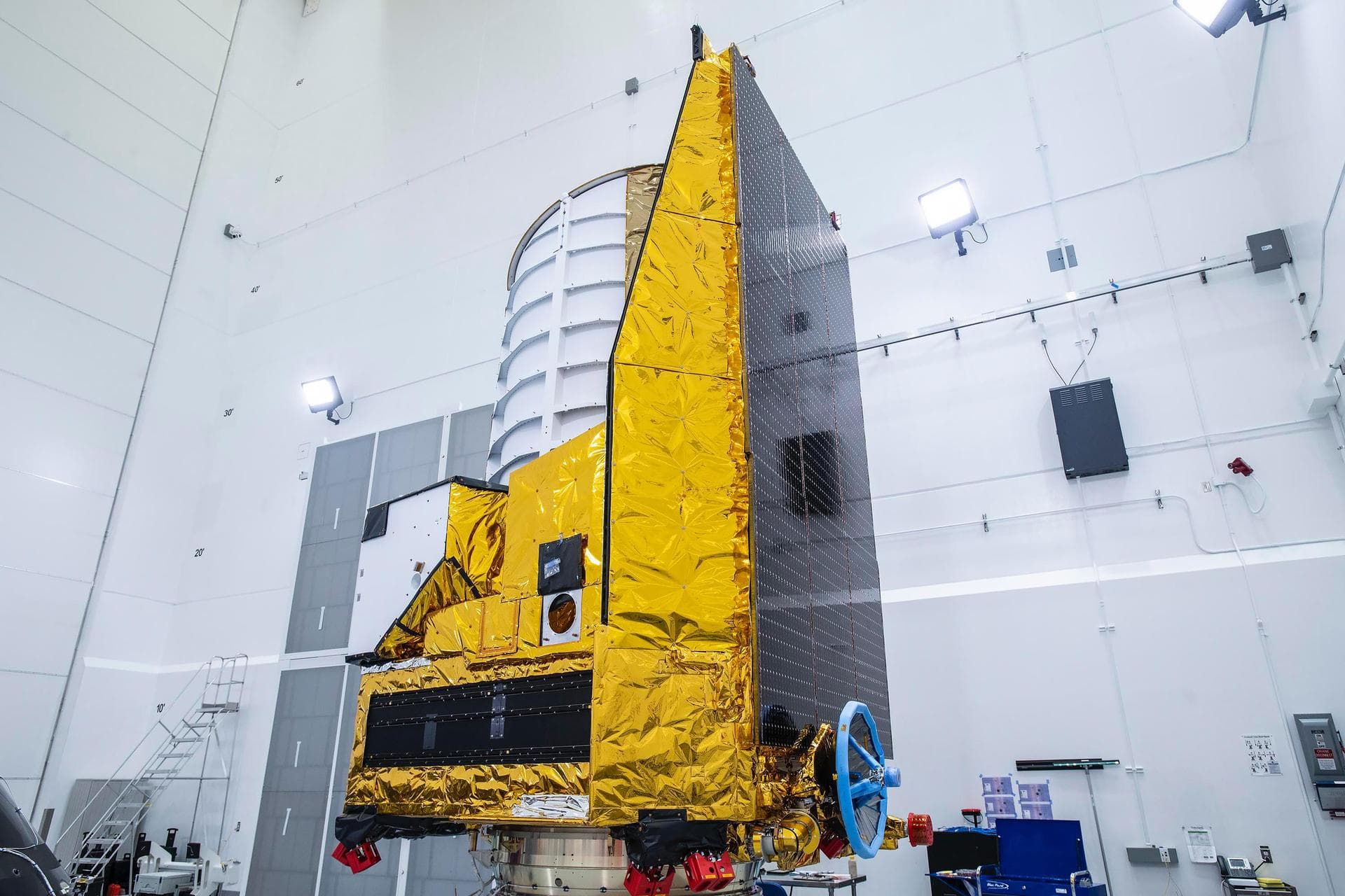 The ESA (European Space Agency) Euclid telescope, with contributions from NASA, is shown here on Friday 23 June, being secured to the adaptor of a SpaceX Falcon 9 rocket before launch. Black solar pan