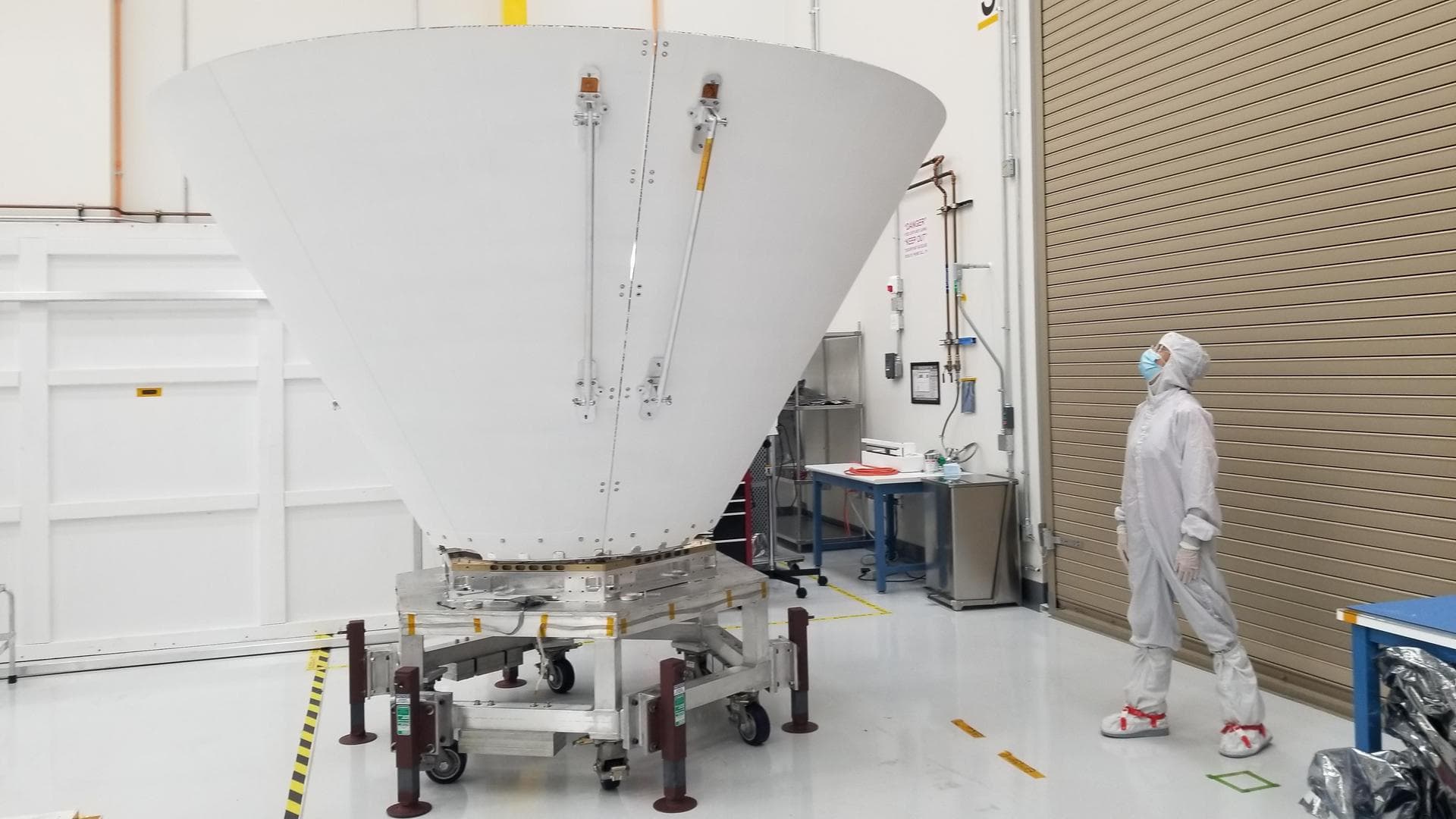 Sara Susca, deputy payload manager and payload systems engineer for the NASA's SPHEREx mission, looks up at one of the spacecraft's photon shields at the agency's Jet Propulsion Laboratory in Southern