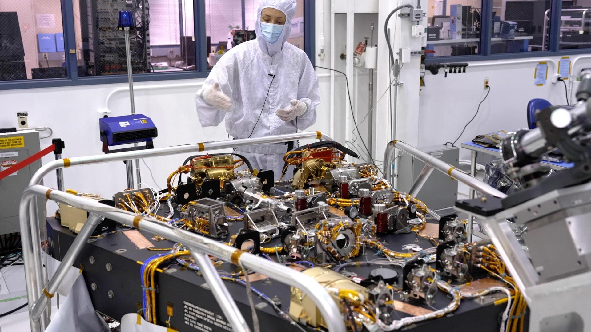 In a clean room at NASA's Jet Propulsion Laboratory in Southern California in October 2023, scientist Vanessa Bailey stands behind the Roman Coronagraph, which has been undergoing testing at the lab.