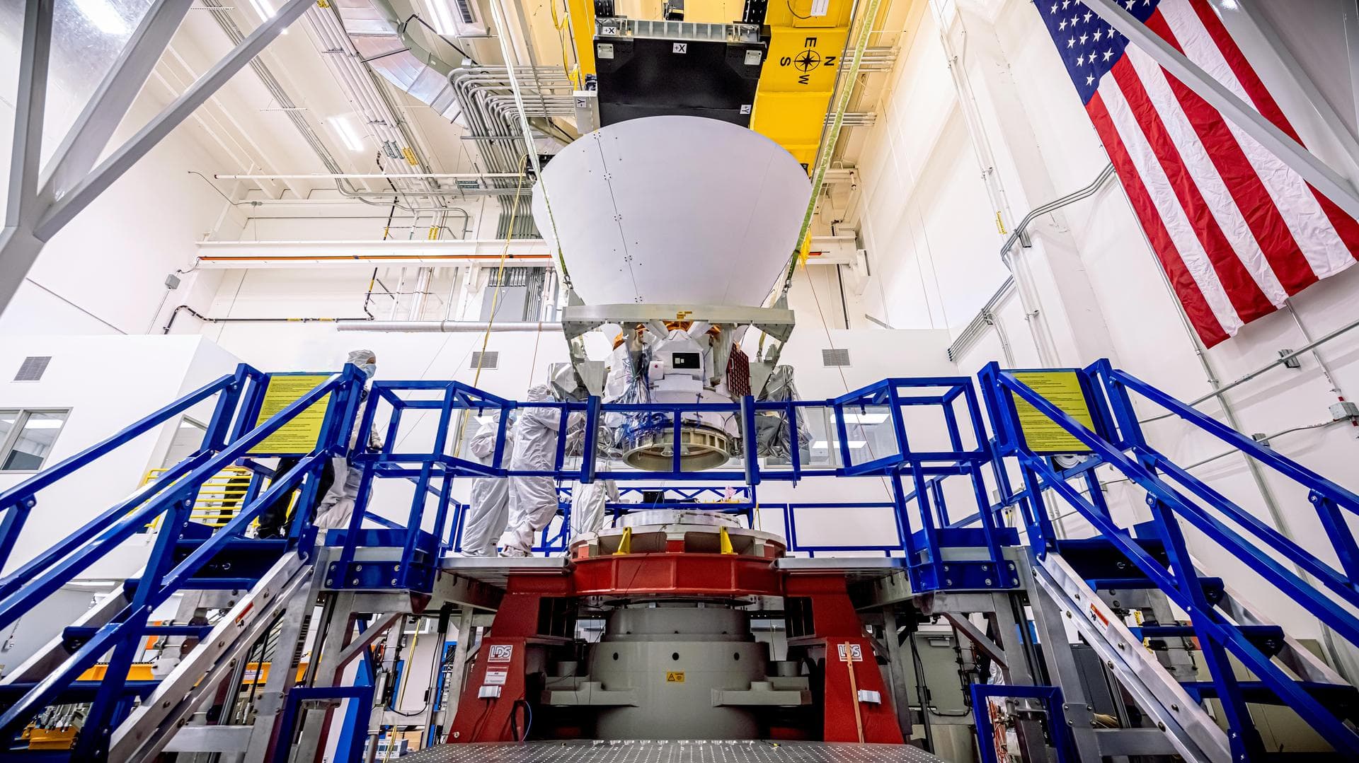 NASA's SPHEREx observatory is lifted and installed onto a vibration table in the Z-axis configuration at BAE Systems in Boulder, Colorado, in August 2024. In this test, the spacecraft is subjected to 