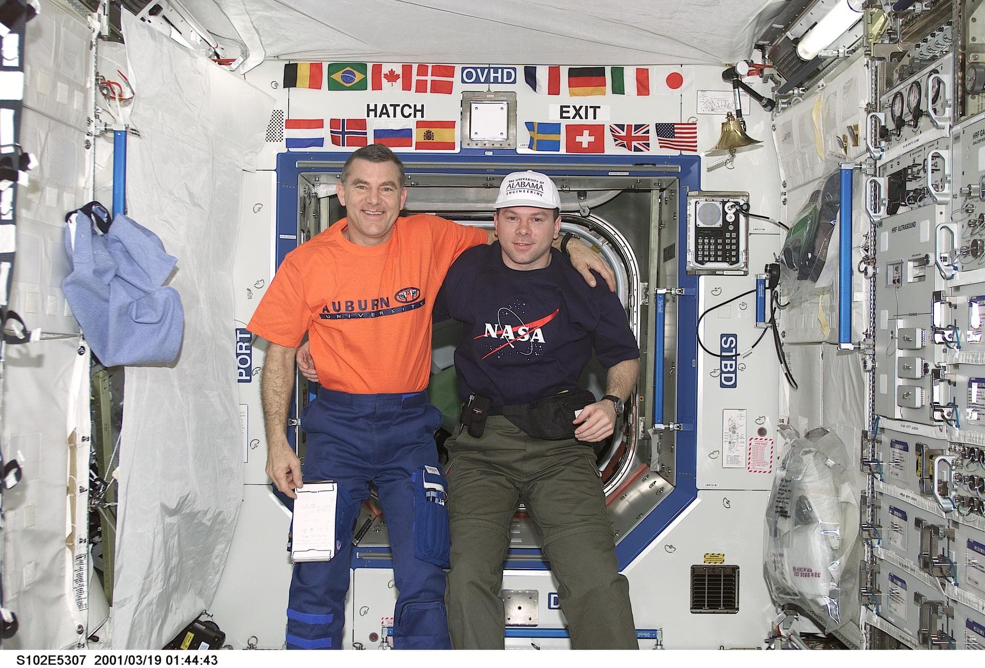STS102-E-5307 (19 March 2001) --- Astronauts James S. Voss (left) and James M. Kelly share a friendly moment onboard the International Space Station's U.S. laboratory Destiny in spite of the long-stan