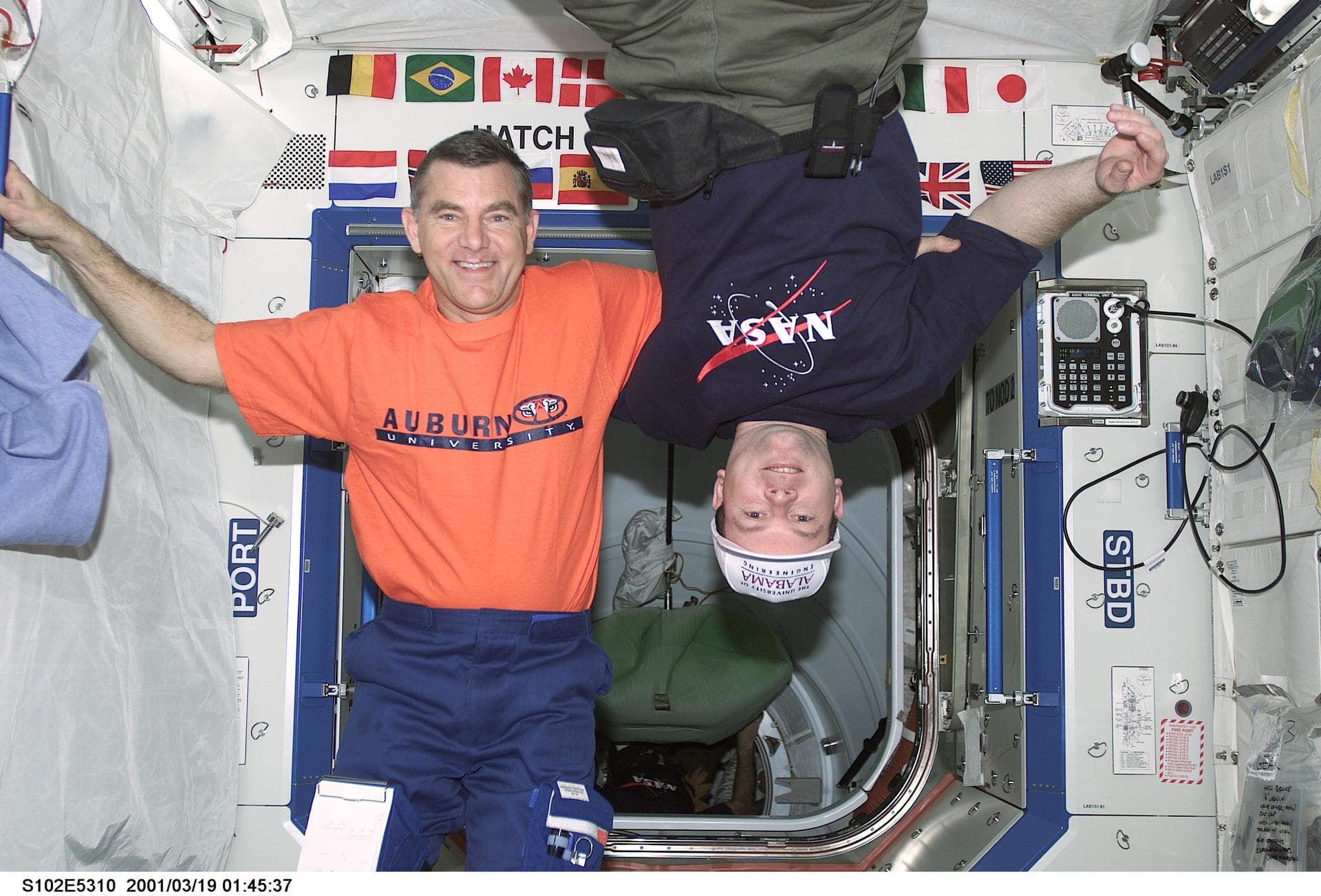 STS102-E-5310 (19 March 2001) --- Astronauts James S. Voss (left) and James M. Kelly share a friendly moment onboard the International Space Station's U.S. laboratory Destiny in spite of the long-stan