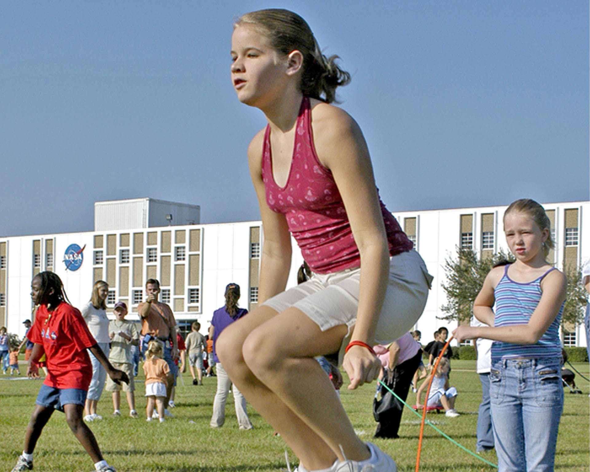 Sarah Dastugue, 11, leaps in the air as Libby Knox, 9, swings a jump rope. The children were participants in Nickelodeon's Worldwide Day of Play celebration at Stennis Space Center (SSC) on Oct. 1. On