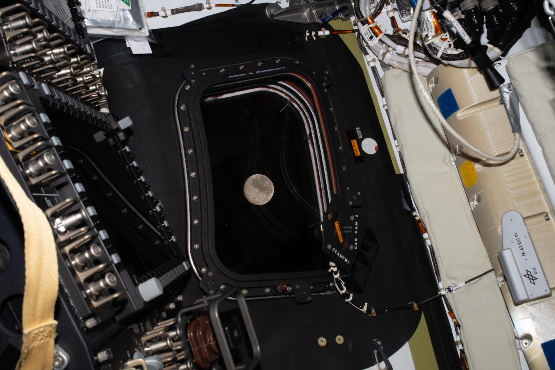 art002e009210 (April 6, 2026) - Before going to sleep on flight day 5, the Artemis II crew snapped one more photo of the Moon, as it drew close in the window of the Orion spacecraft. Orion and the fou