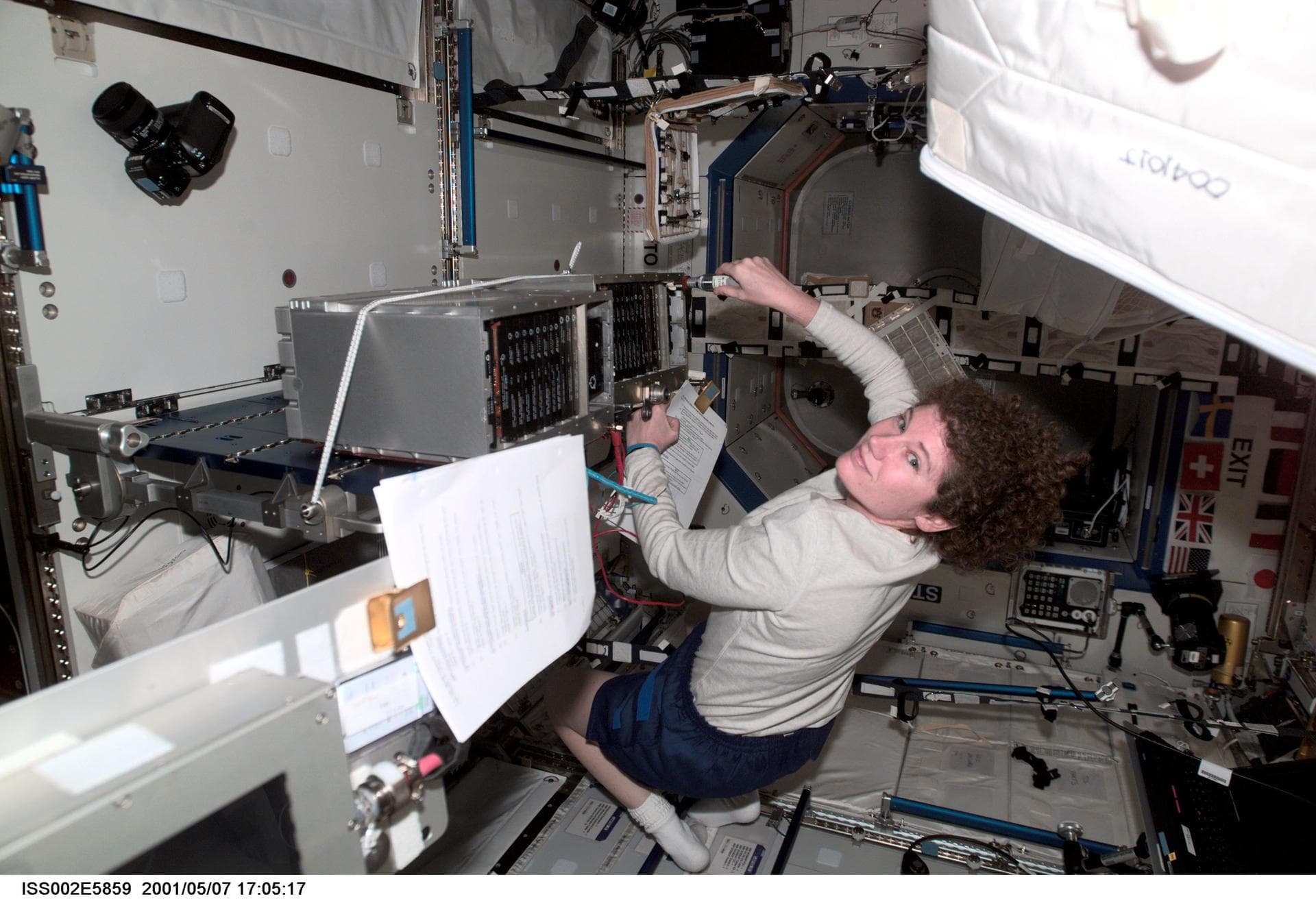 ISS002-E-5859 (7 May 2001) --- Susan J. Helms, Expedition Two flight engineer, works on an Enhanced Space Station Multiplexer / Demultiplexer (ESSMDM) at the Maintenance Work Assembly (MWA) work surfa