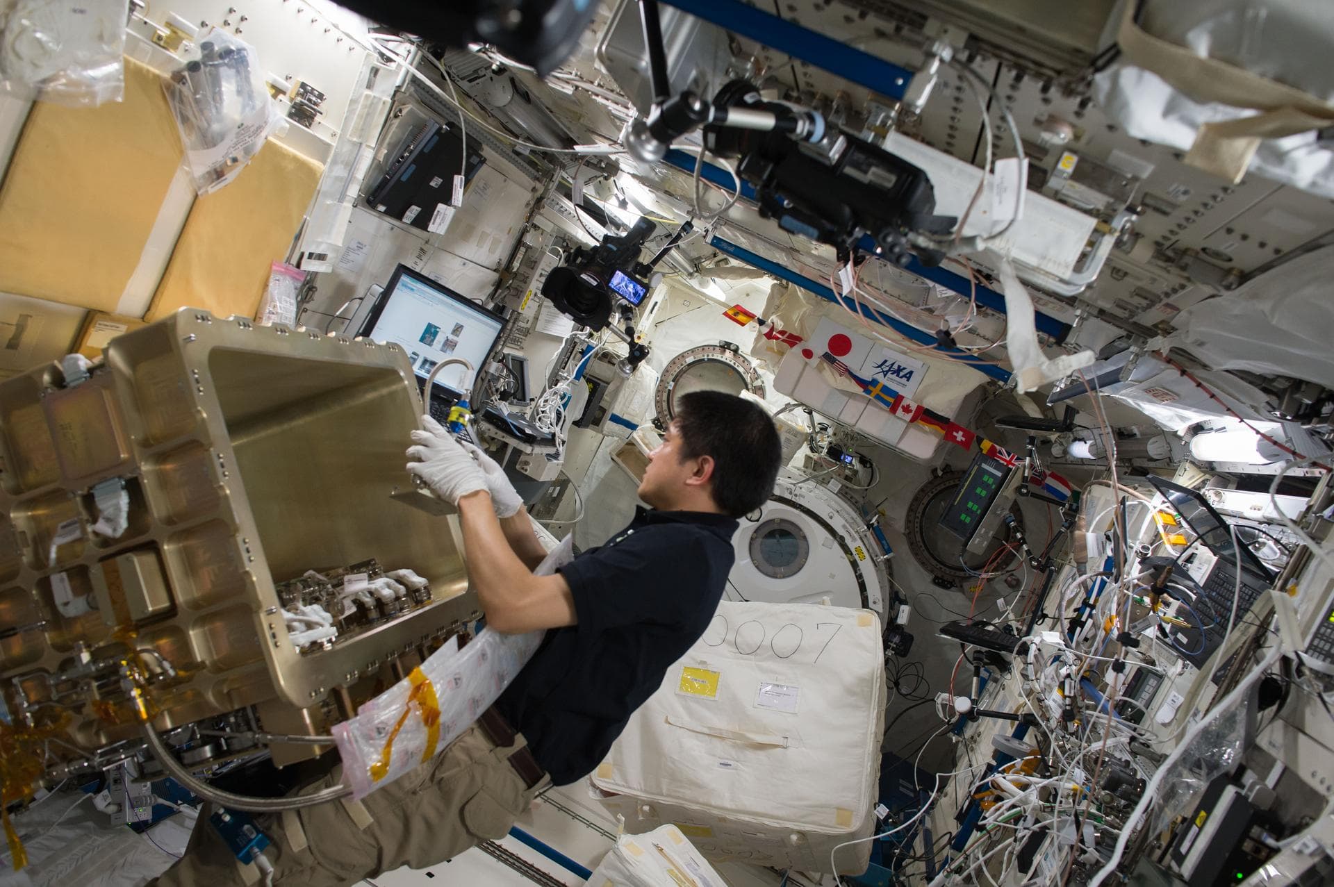 ISS049e011638 (09/27/2016) --- Expedition 49 crewmember Takuya Onishi of JAXA works on the setup of the Group Combustion Module (GCM) inside the Japanese Experiment Module. The GCM will be used to hou