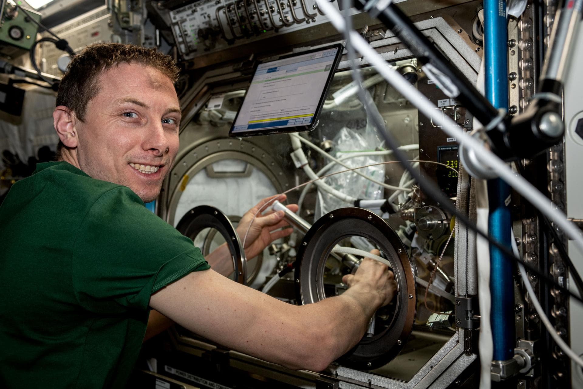 iss069e060322 (August 15, 2023) -- NASA astronaut Woody Hoburg swaps samples for a space manufacturing study inside the Microgravity Science Glovebox (MSG) in the International Space Station's U.S. De