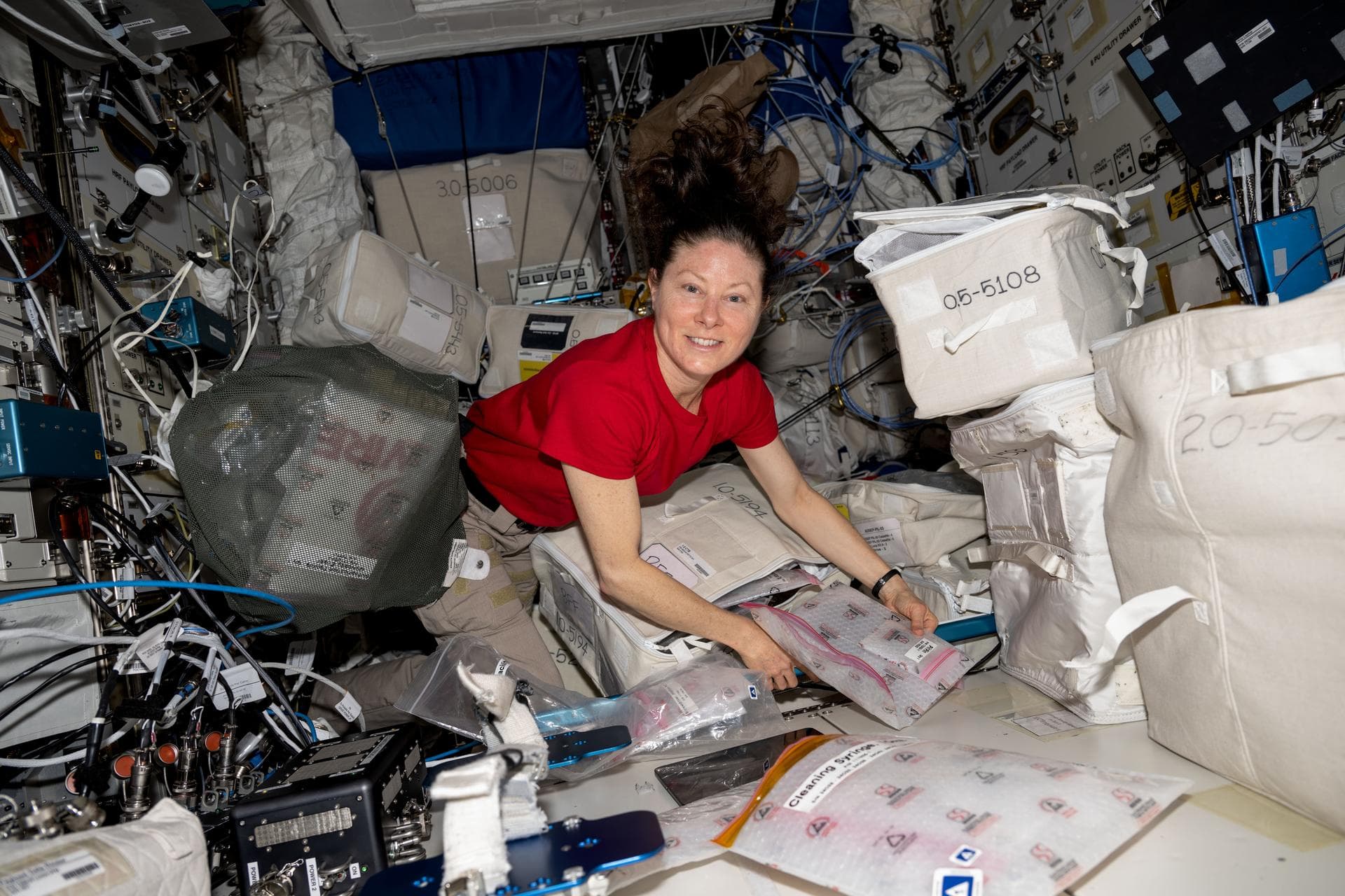 iss071e403579 (July 23, 2024) --- NASA astronaut and Expedition 71 Flight Engineer Tracy C. Dyson unpacks and examines research gear that is part of the BioFabrication Facility (BFF) located inside th