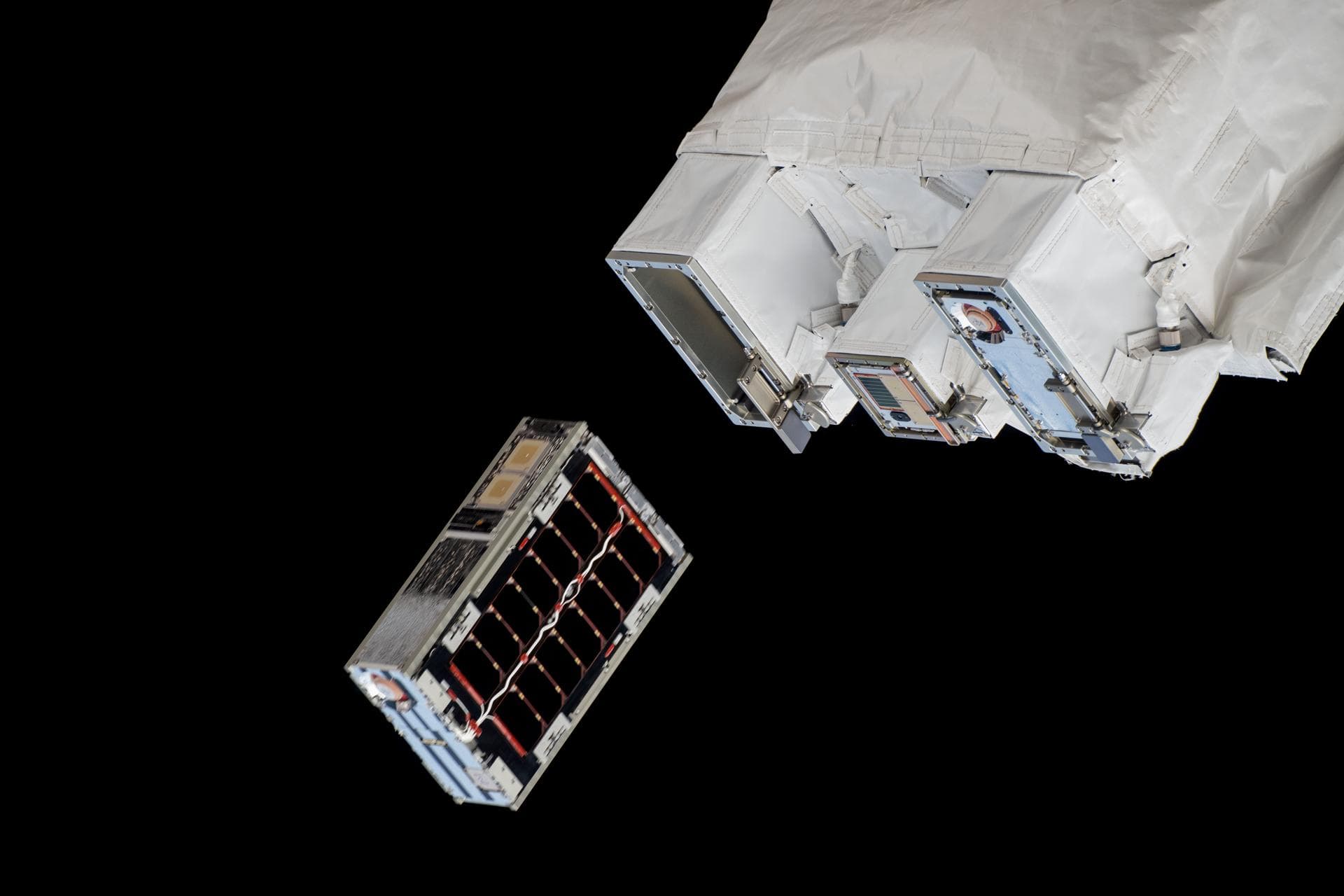 iss072e351732 (Dec. 9, 2024) --- A CubeSat is ejected into Earth orbit from a small satellite orbital deployer attached to the International Space Station's Kibo laboratory module. A series of CubeSat