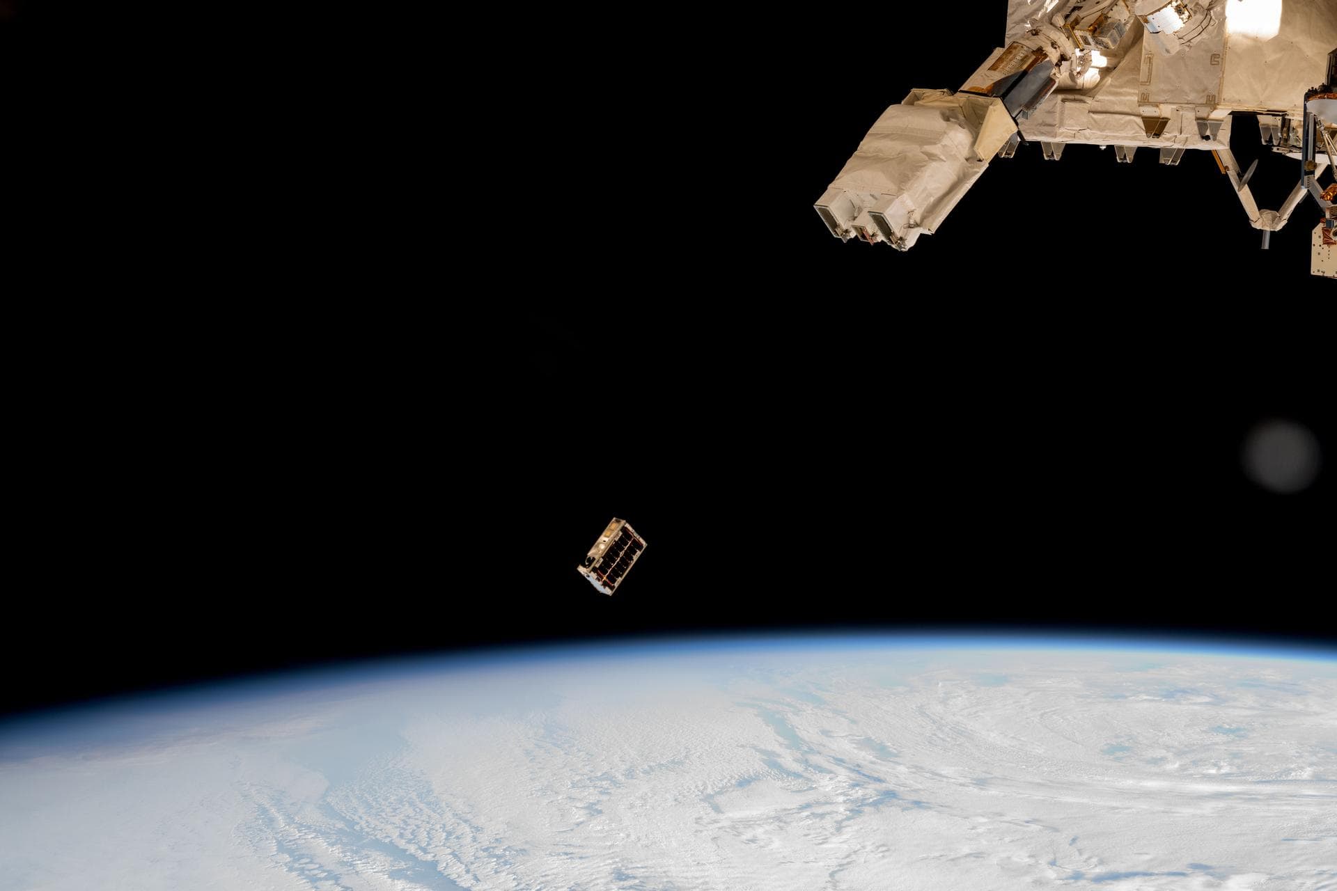 iss072e352225 (Dec. 9, 2024) --- A CubeSat is ejected into Earth orbit from a small satellite orbital deployer attached to the International Space Station's Kibo laboratory module. A series of CubeSat