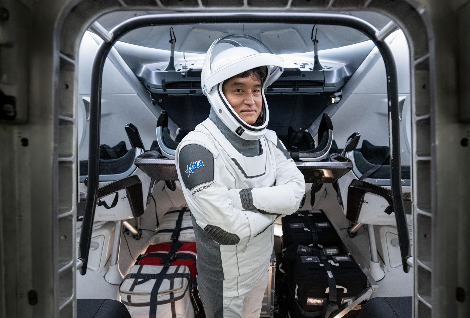 jsc2024e079794 (Nov. 20, 2024) --- NASA’s SpaceX Crew-10 Mission Specialist Takuya Onishi of JAXA (Japan Aerospace Exploration Agency) is pictured inside a mockup of a Dragon cockpit at the company's 