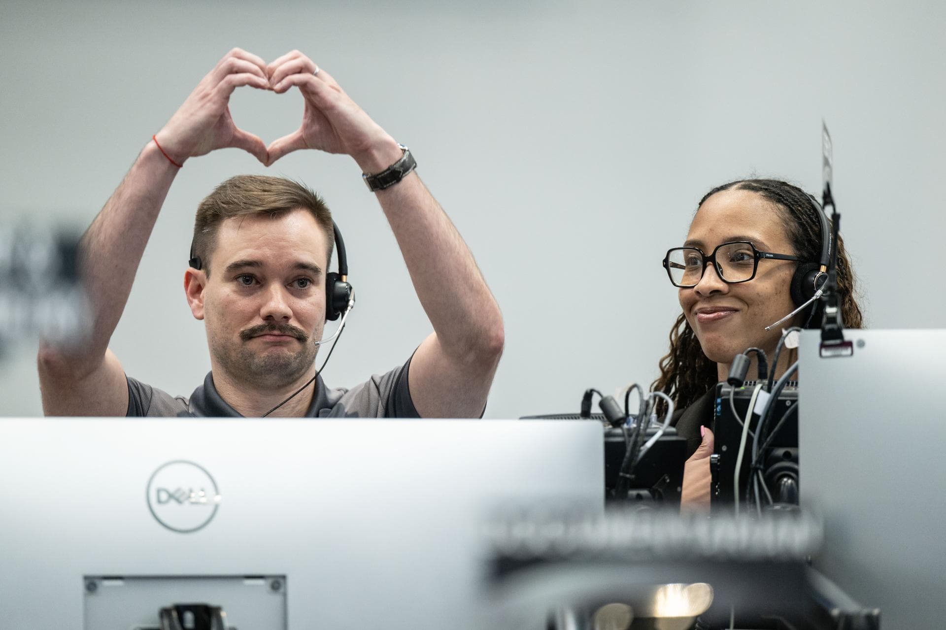 Artemis II deputy lunar science lead, Jacob Richardson, left, and Artemis II lunar science team members, Kiarre Dumes, react to the astronauts' verbal observations of the Moon during their flyby on Ap