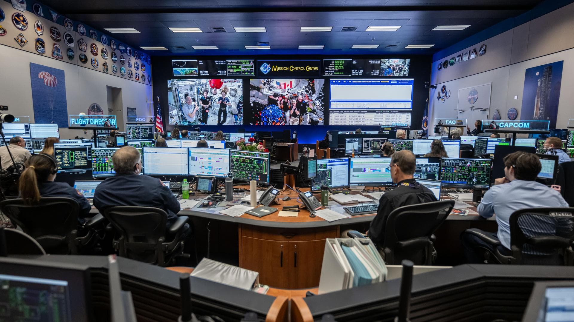 jsc2026e021201 (April 7, 2026) - Members of the International Space Station Expedition 74 (left) and Artemis II (right) crews are seen at once on the screens inside the International Space Station fli