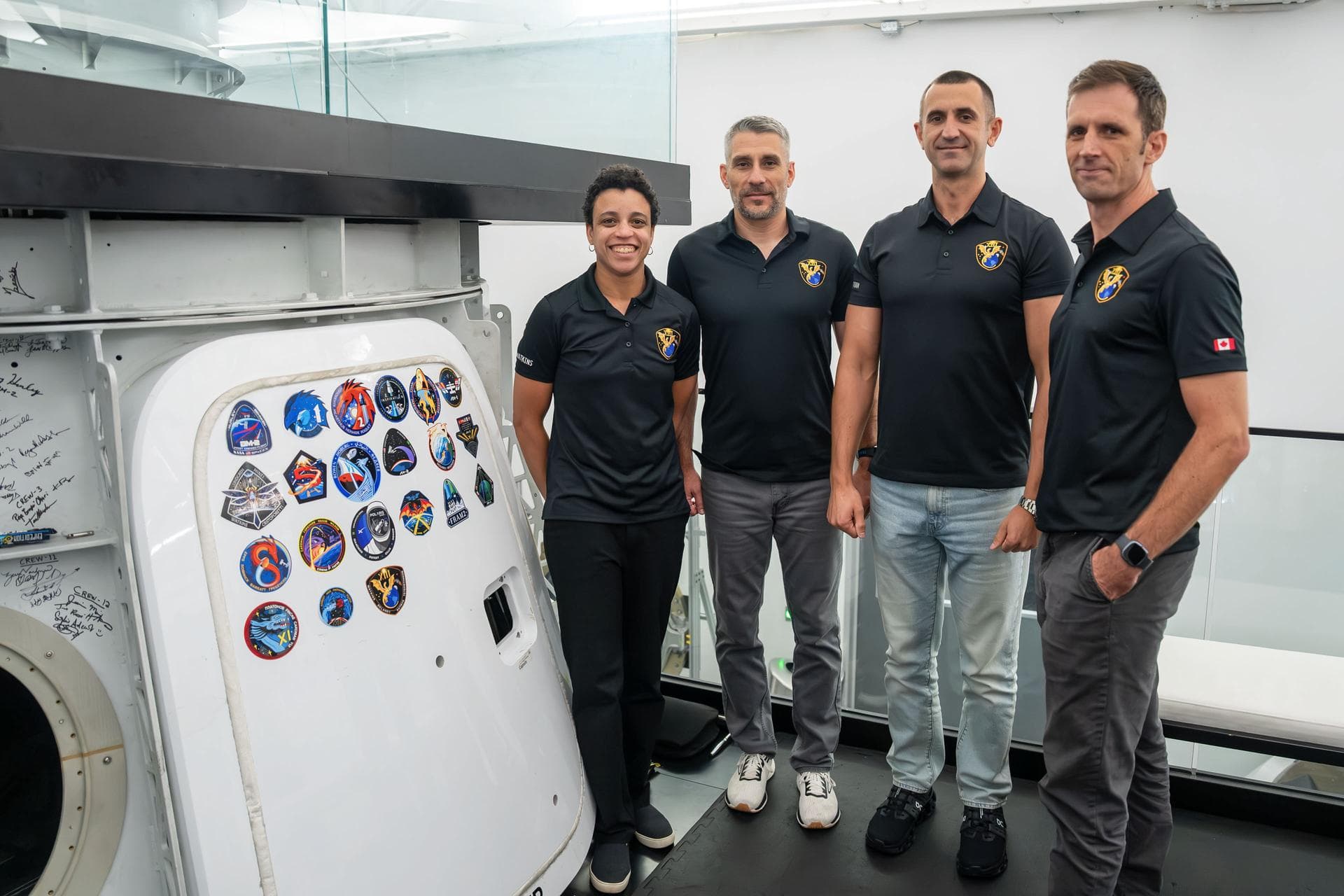 jsc2026e406103 (July 30, 2026) --- The four members representing NASA's SpaceX Crew-13 mission to the International Space Station pose for a portrait next to the Dragon spacecraft mockup after complet