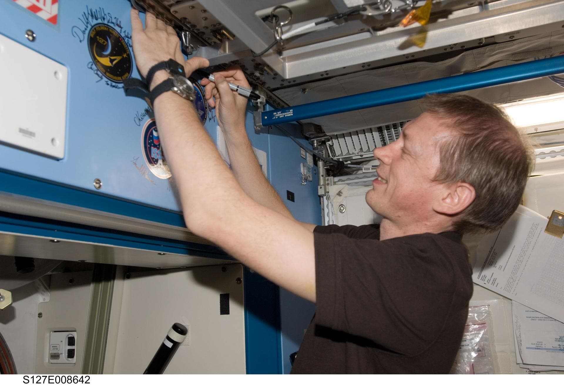 S127-E-008642 (25 July 2009) --- Flight day 11 activities for the joint shuttle-station crews included the traditional autographing of the station. European Space Agency astronaut Frank DeWinne, Exped