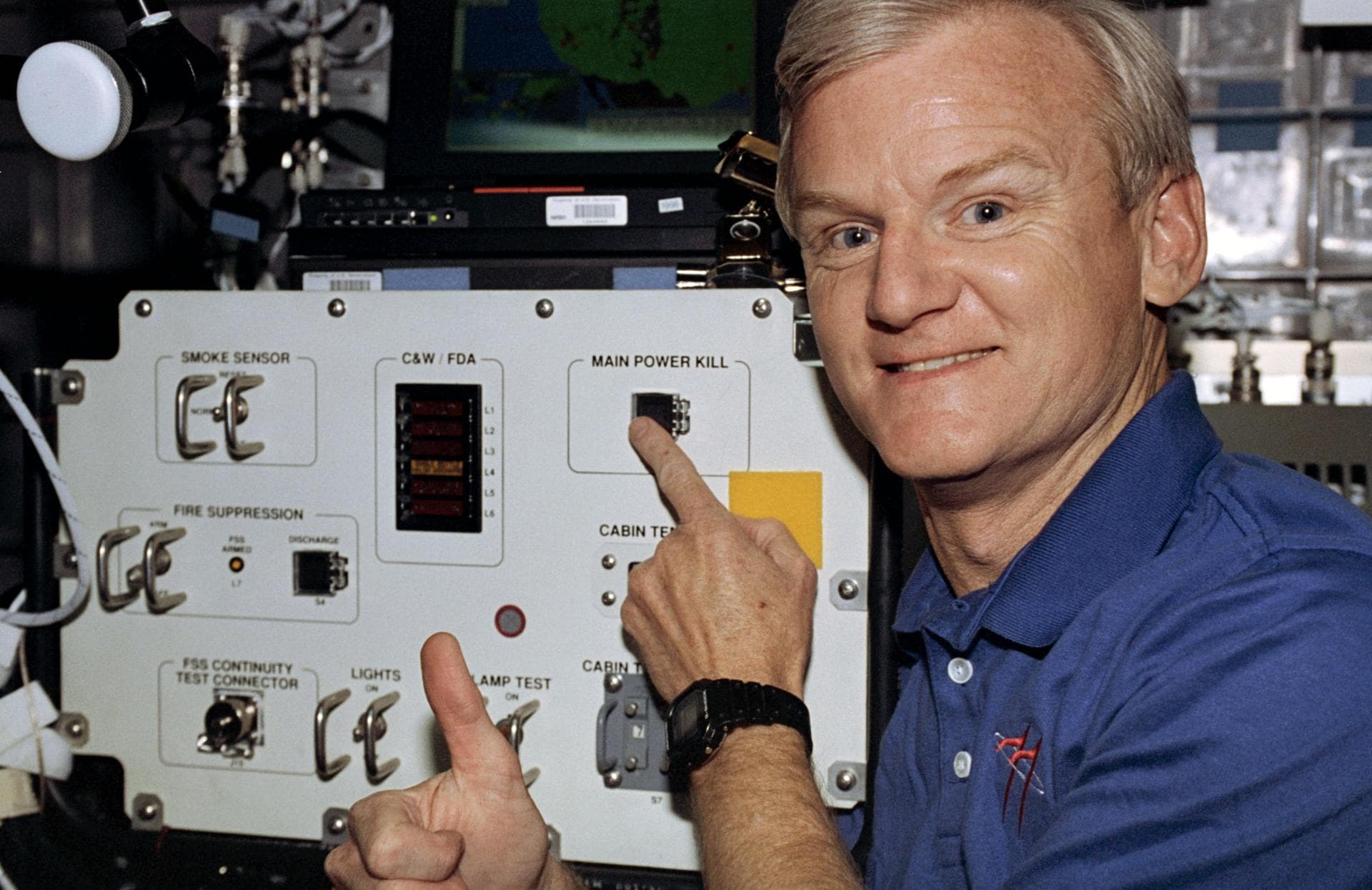 STS077-372-019 (19-29 May 1996) --- Astronaut John H. Casper, commander, holds his finger on the power kill switch on the Spacehab 4 Module aboard the Earth-orbiting Space Shuttle Endeavour.  Casper a