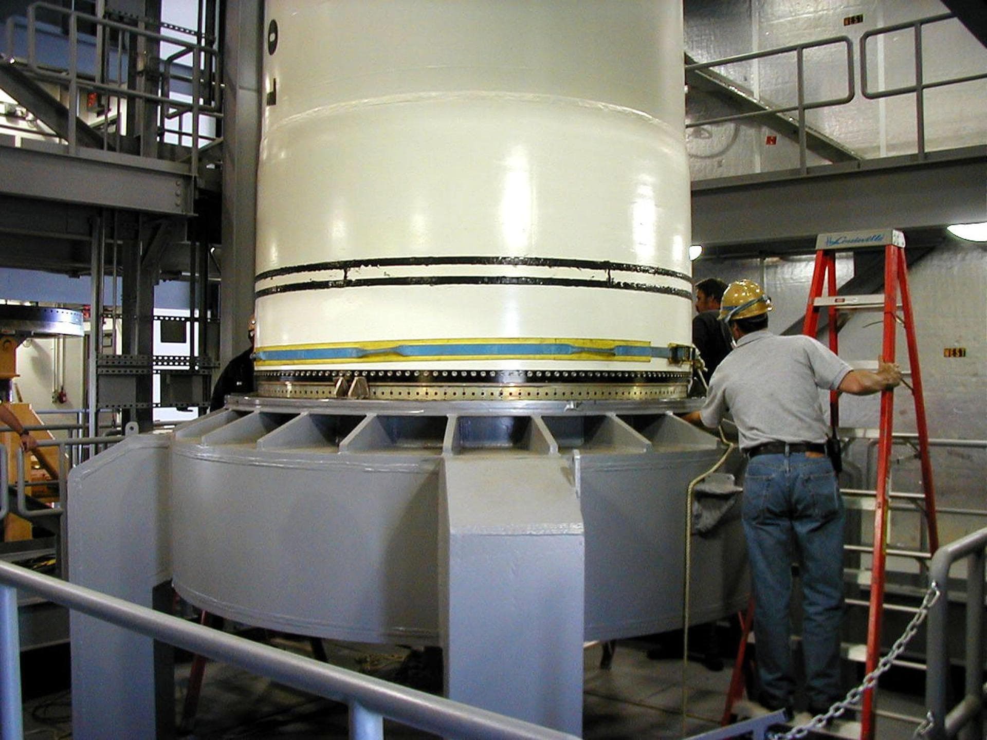 KODIAK ISLAND, Alaska -- Technicians inspect and secure Castor 120, the first stage of the Athena 1 launch vehicle, on the launch mount at Kodiak Island, Alaska, as processing for the launch of Kodiak