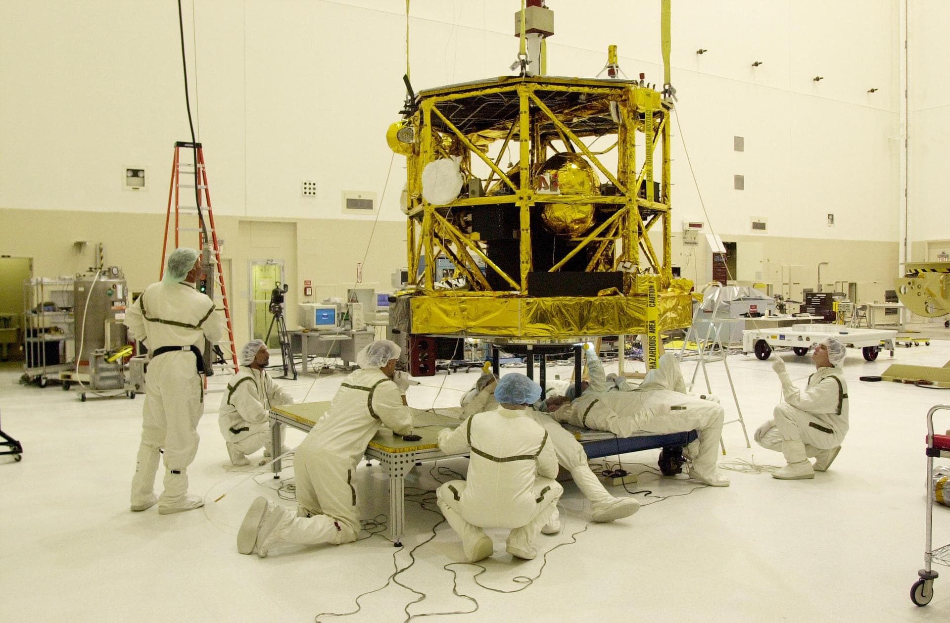 KENNEDY SPACE CENTER, FLA. -- In the Spacecraft Assembly and Encapsulation Facility 2, workers watch closely as the CONTOUR spacecraft is lowered into place over the apogee kick motor to which it will