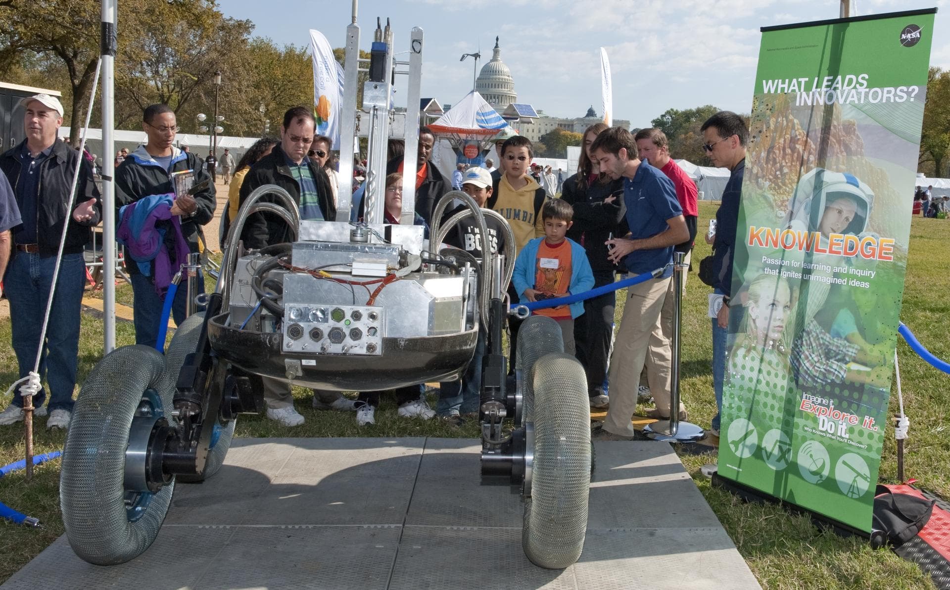 Visitors to the USA Science and Engineering Festival look on at one of the many exhibits, Saturday, Oct. 23, 2010, on the National Mall in Washington. NASA, joined with more than 500 science organizat